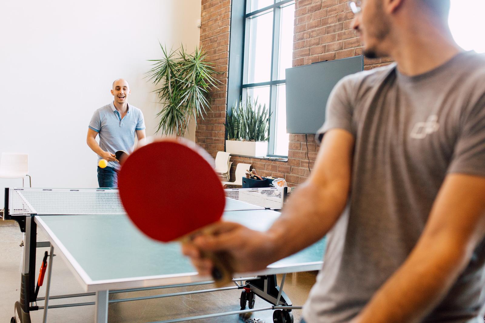 Employees playing ping pong