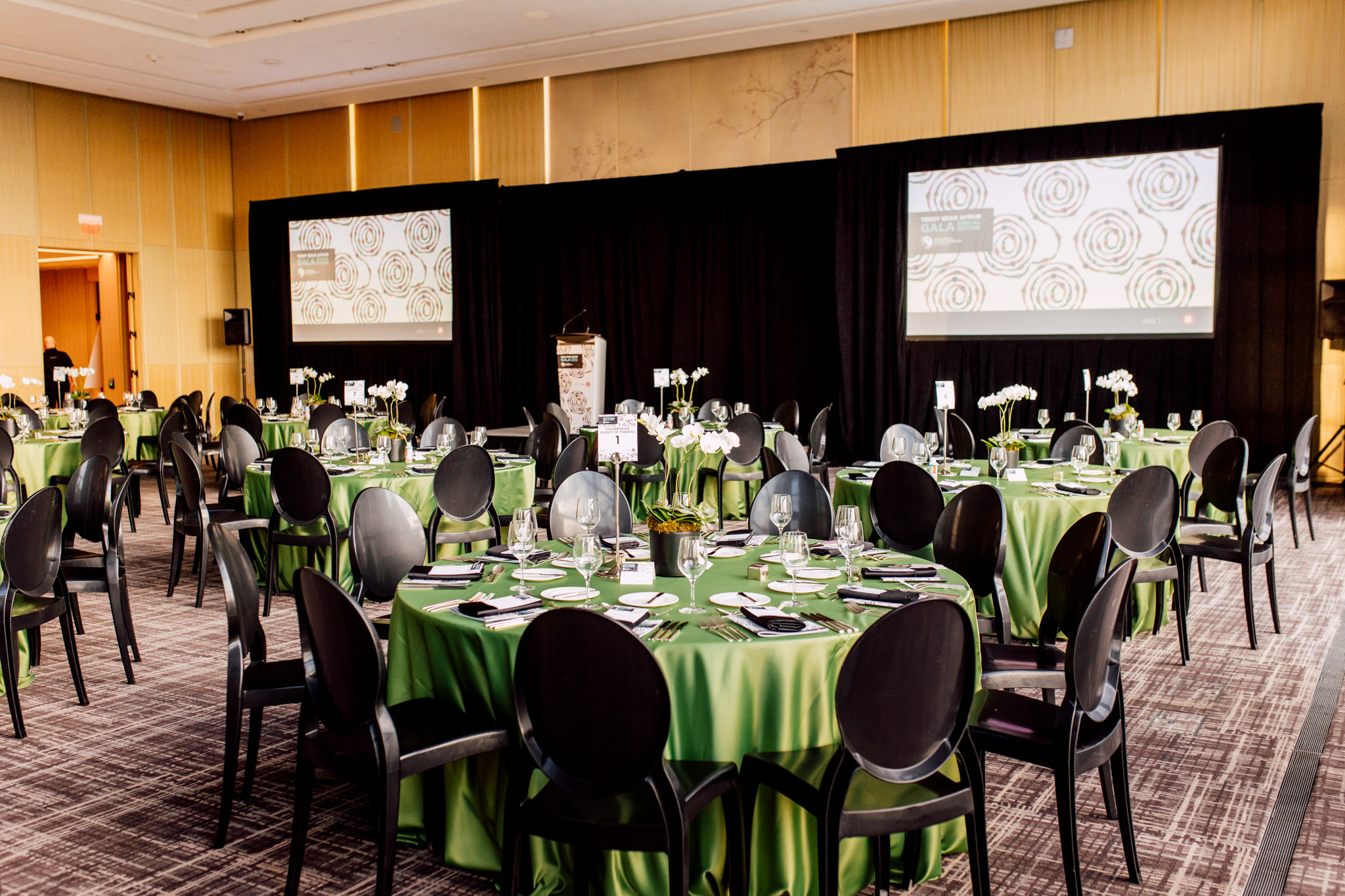 A banquet room with black and green decor.
