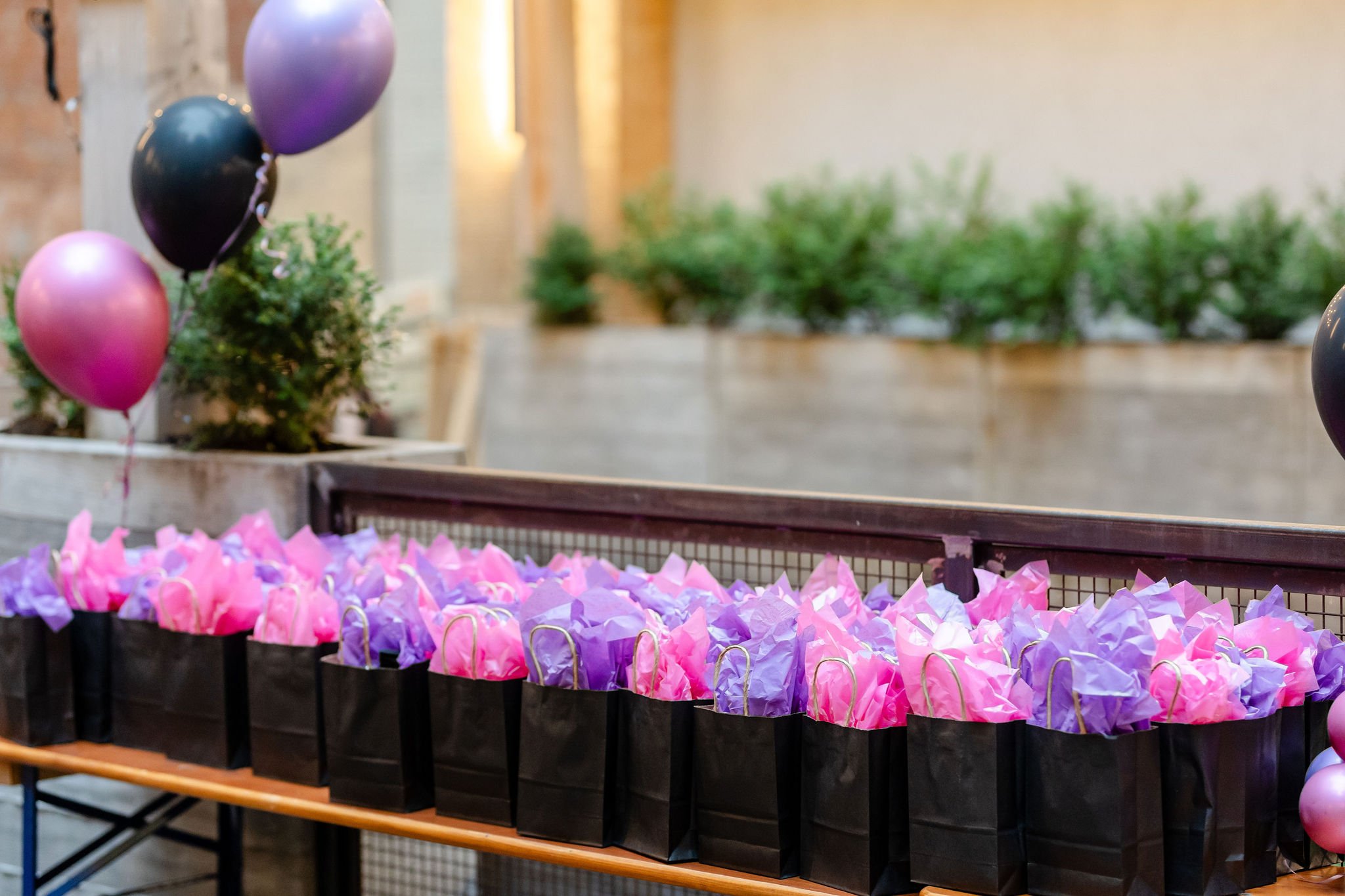 A visually captivating social event photography scene featuring a vibrant arrangement of black and purple bags and balloons.