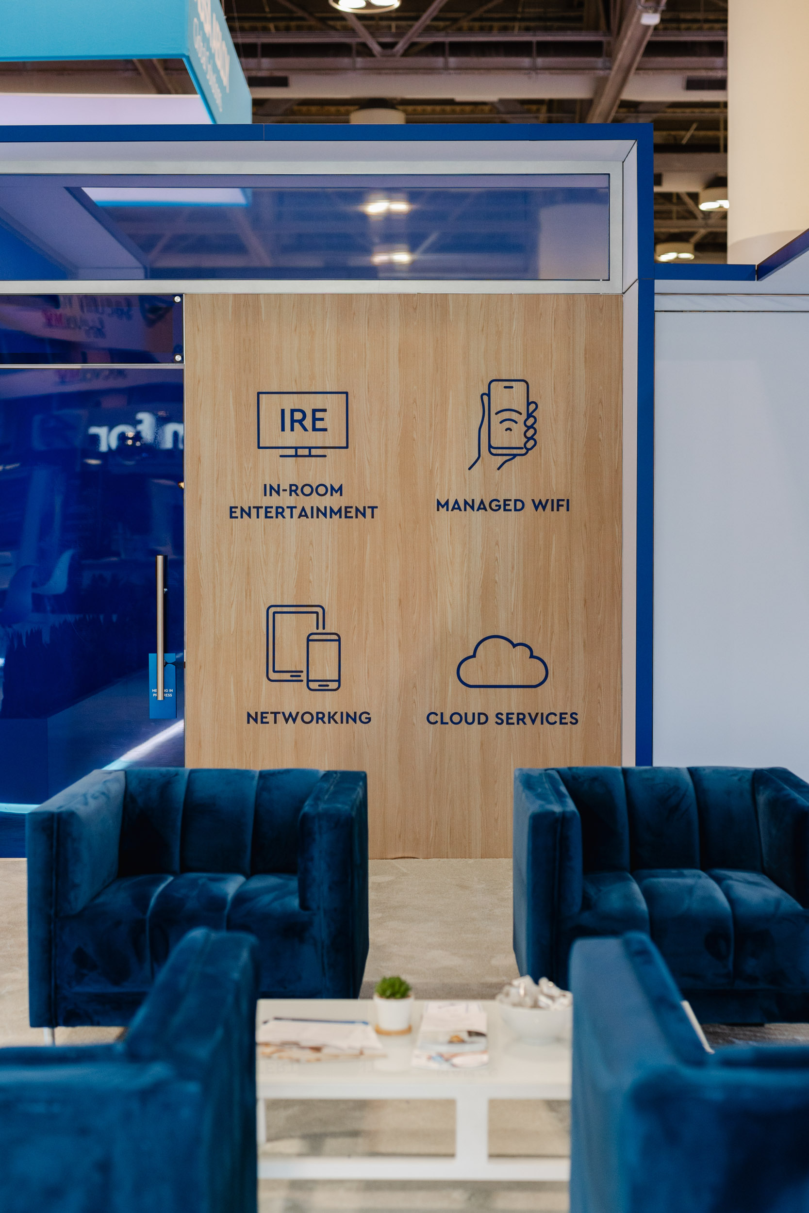 A Toronto trade show booth featuring blue couches against a blue wall.