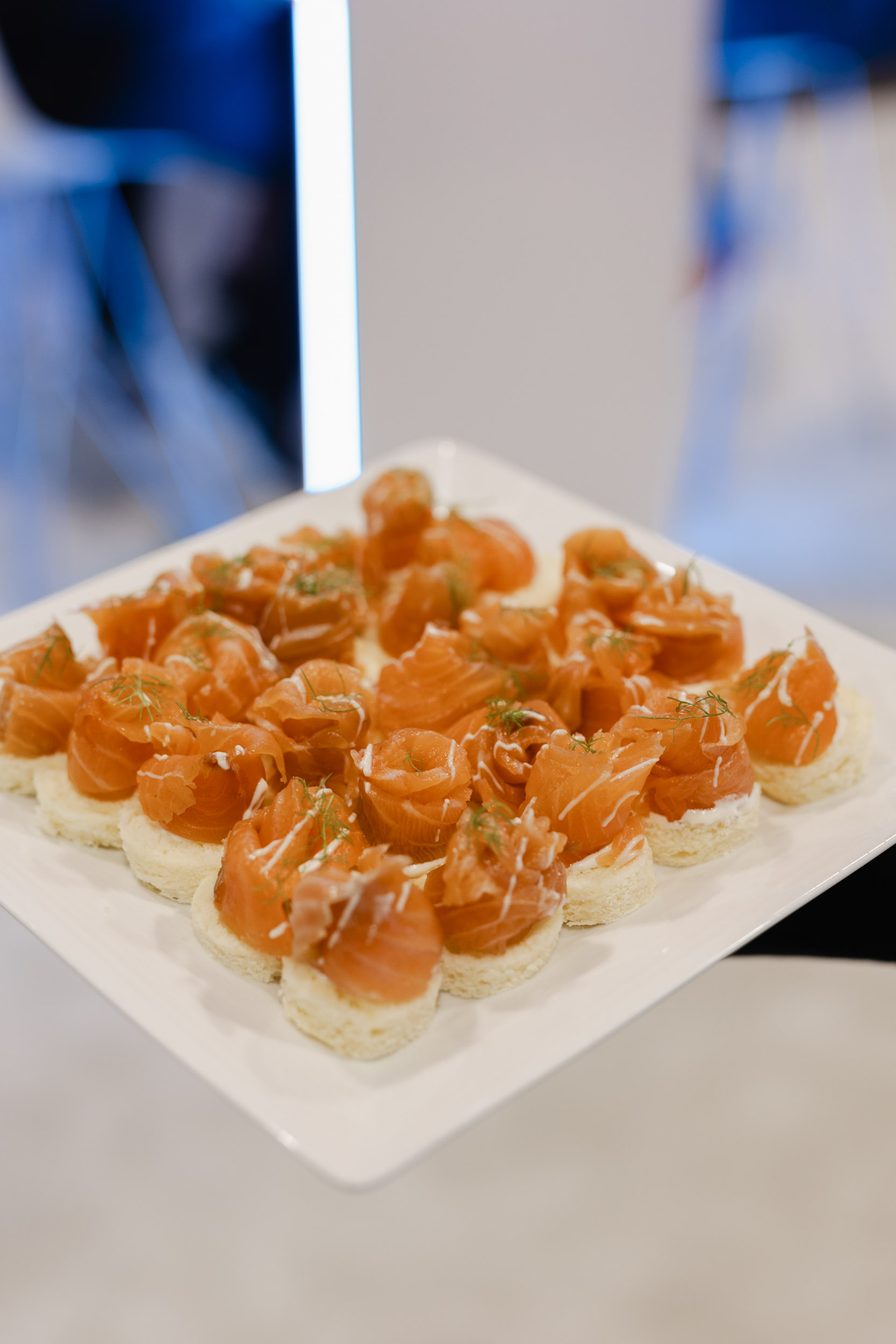 A person is holding a plate of food at a Toronto trade show.