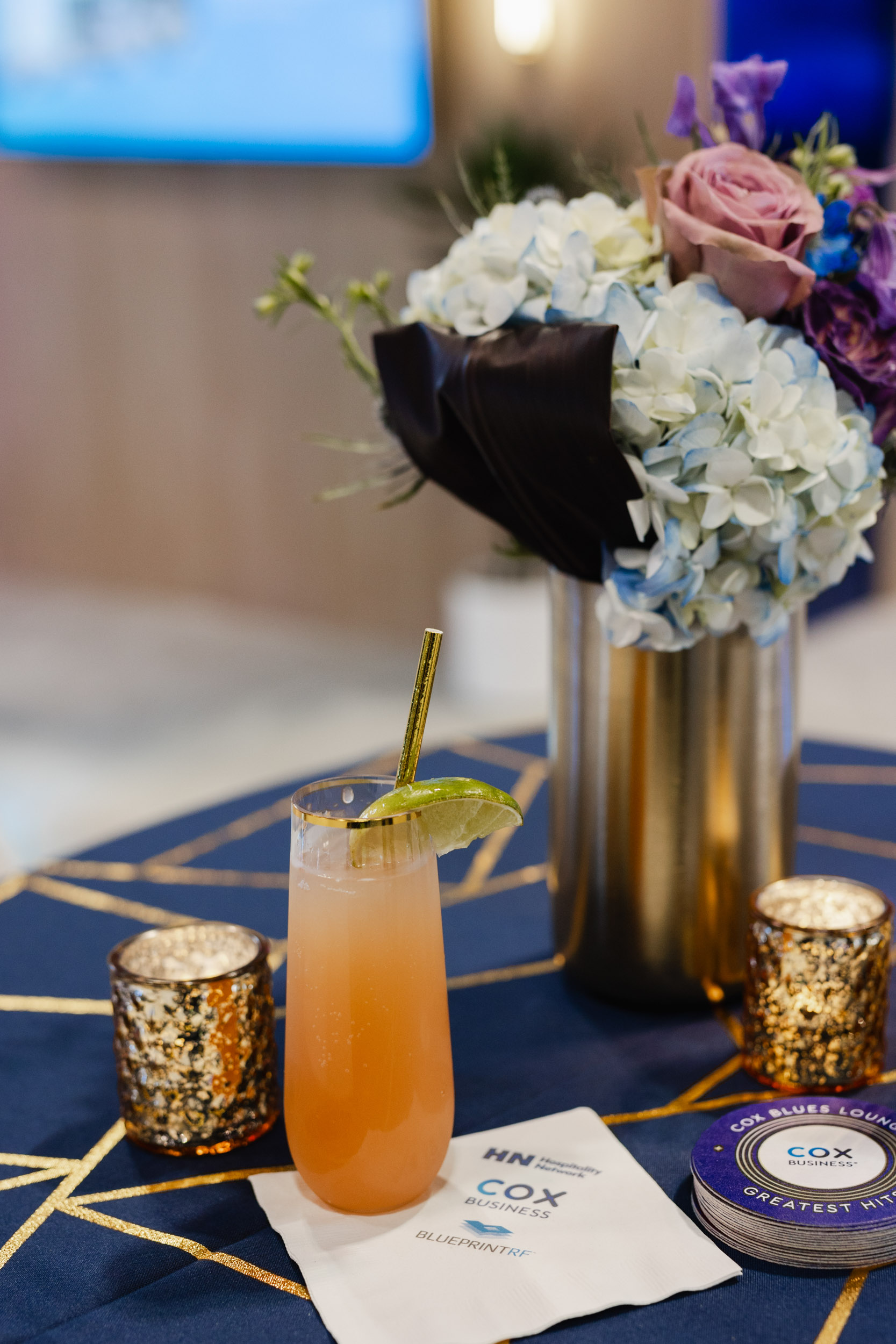 Toronto Trade show photography: A cocktail is sitting on a table in the midst of flowers.