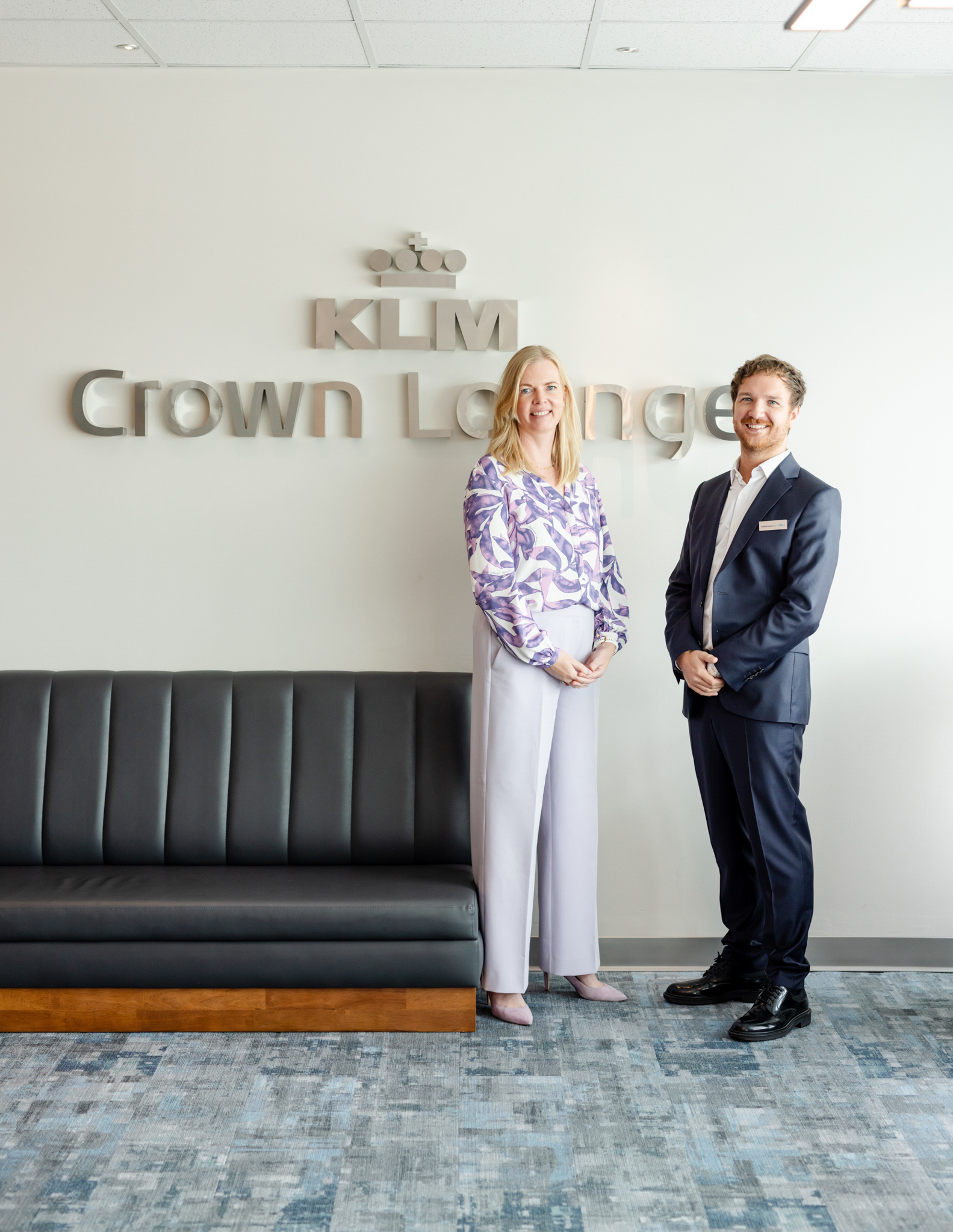 Grand Opening Photography of two people in front of the Crown Lounge sign.