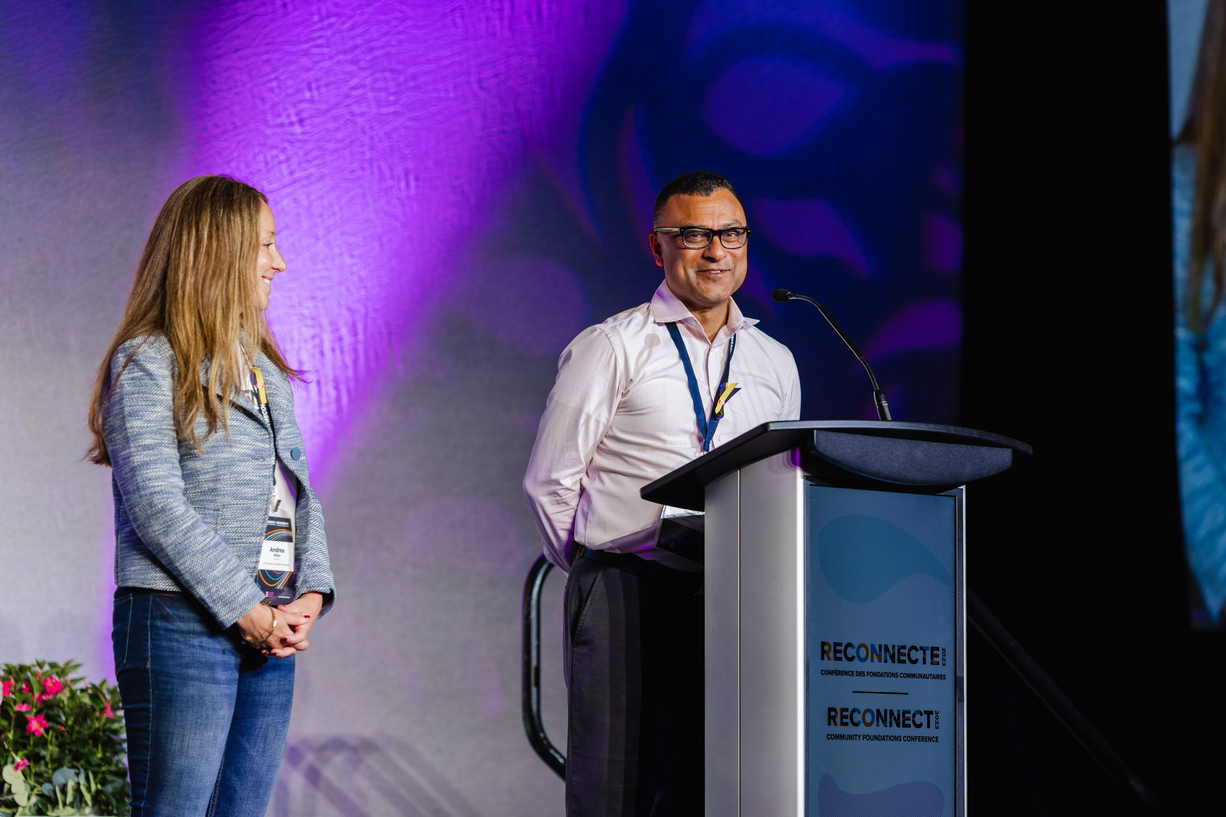 Conference Photography: Two people, one man and one woman, standing at a podium.