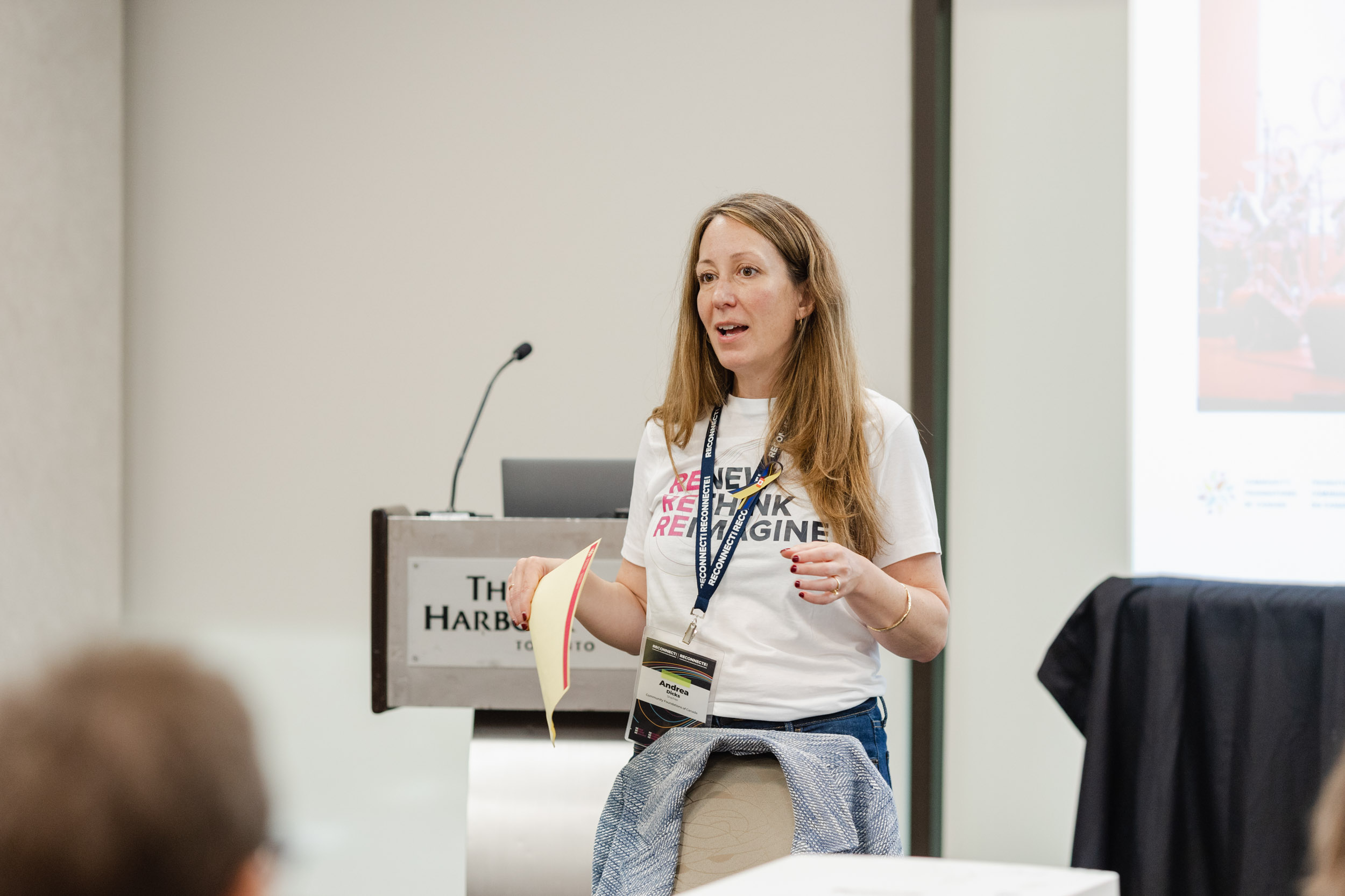 A woman presenting at a conference.