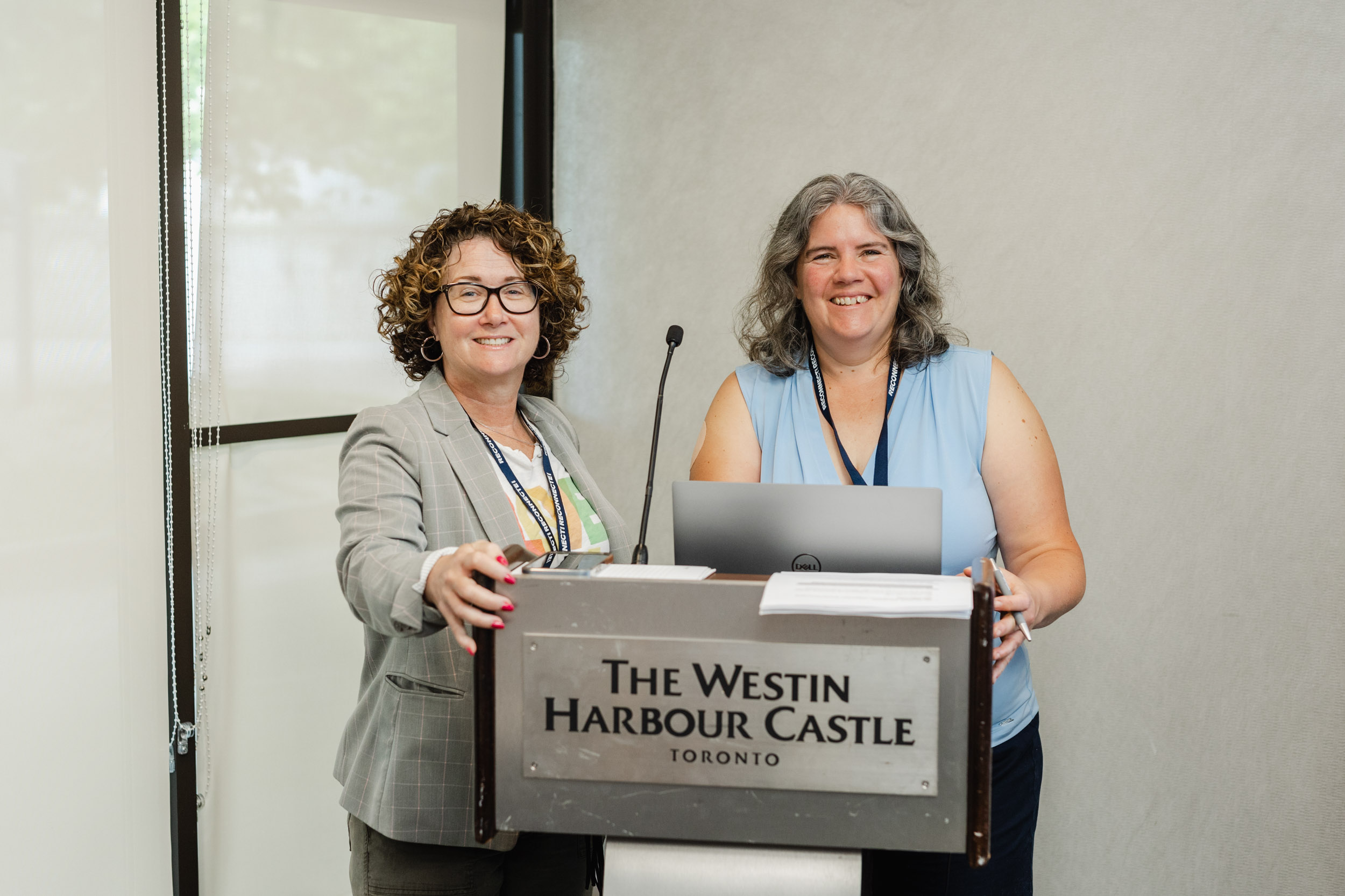 Conference Photography: Women on podium.