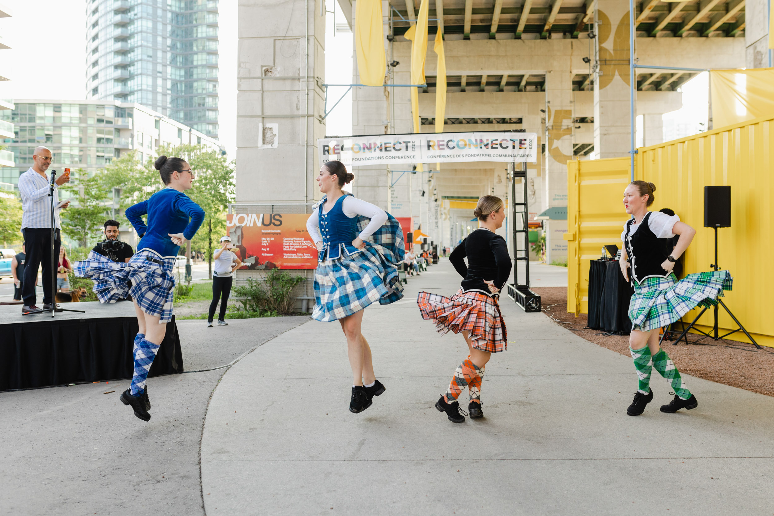 Photograph of Scottish dancers in kilts performing during a conference.