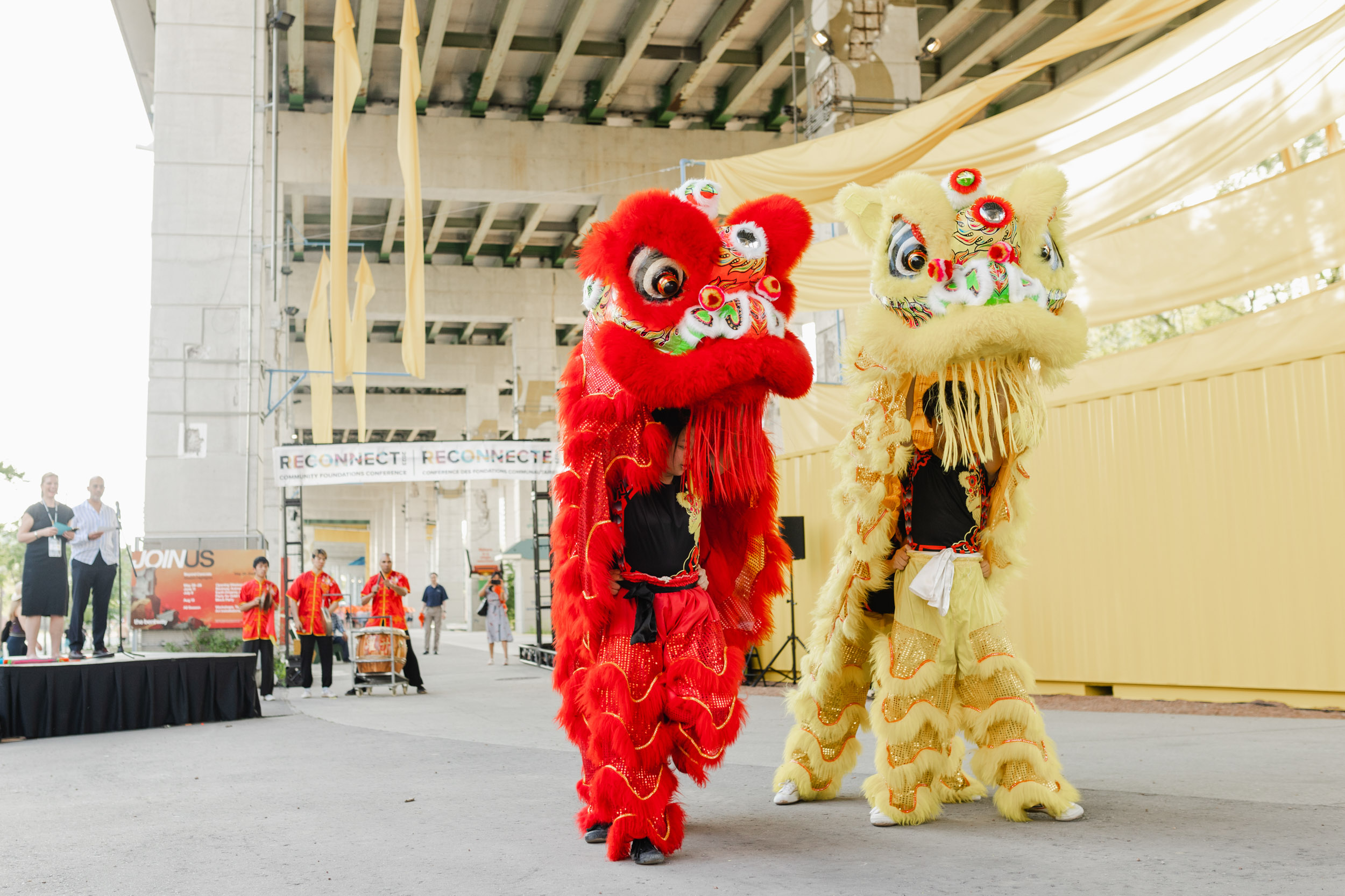 Conference photography of lion dancers on stage.
