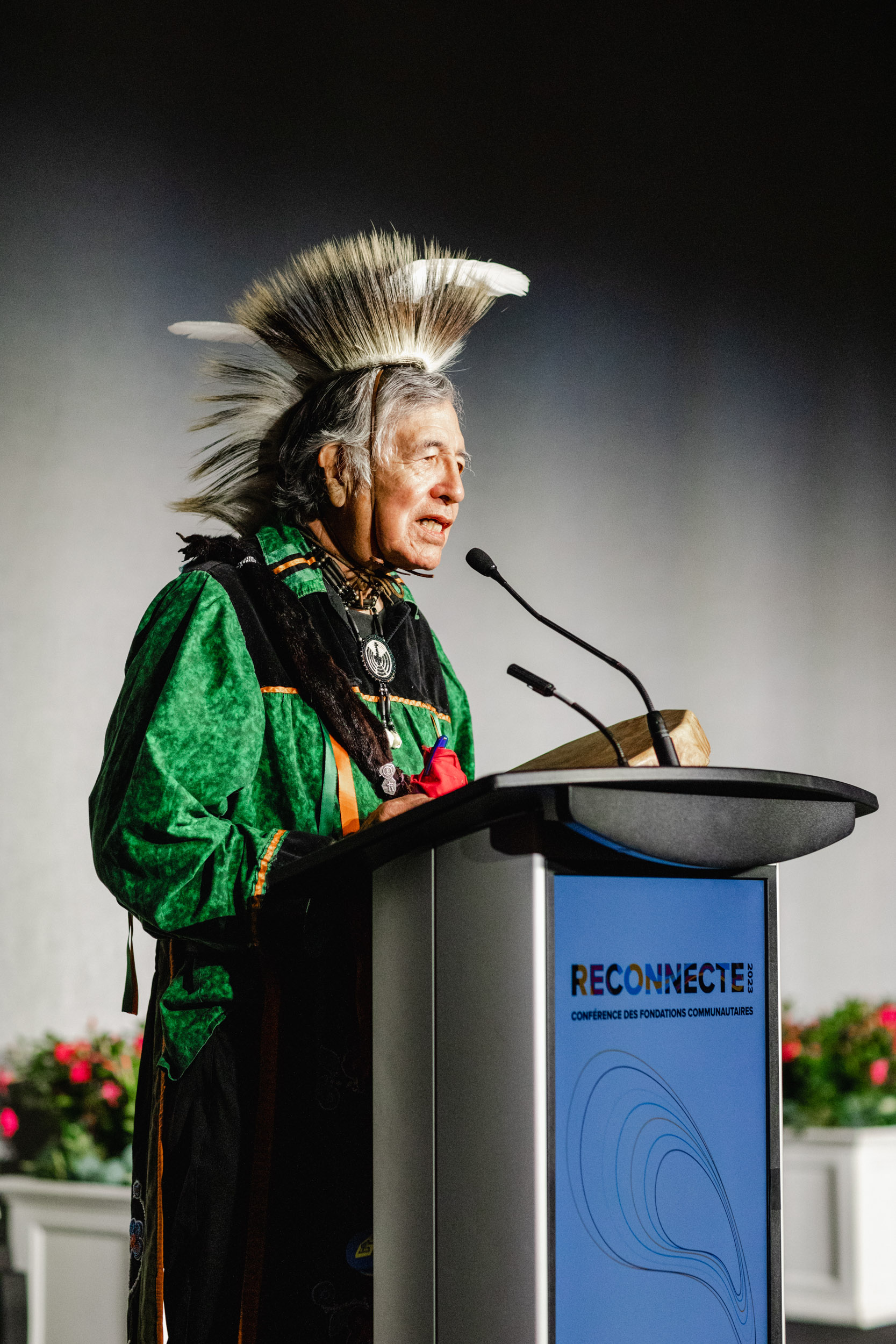 A native american man speaking at a podium at a conference.