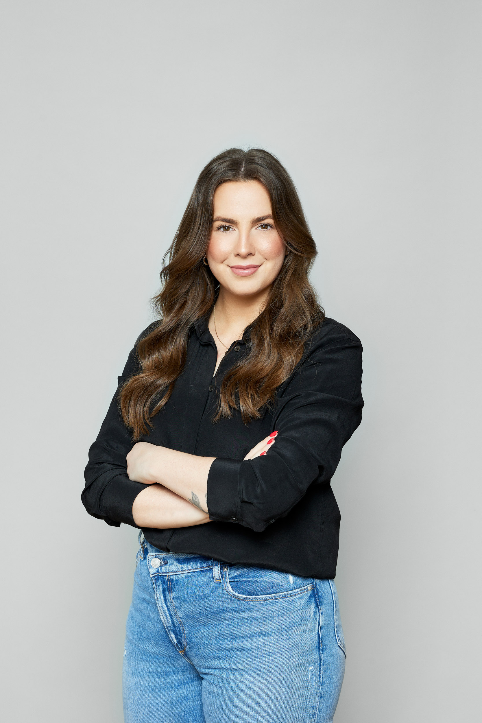 A woman in jeans and a black shirt posing for a photo.