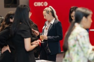 A group of people talking at a grand opening event.