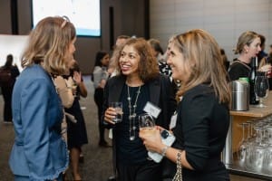 A group of women networking at a business event.