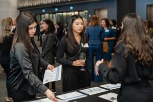 A group of women at a grand opening event, captured in photography.