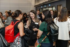 A group of women networking at a business event.