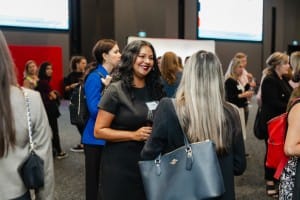 A group of women networking at a business event.