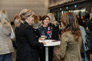 A group of women networking at a business event.