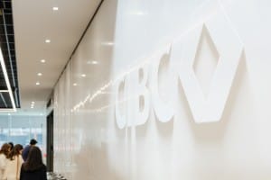 A group of people walking down a hallway during a Grand Opening event, captured in Photography with the cbc logo.