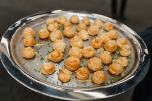 Grand Opening Photography of a person holding a tray of small pastries.