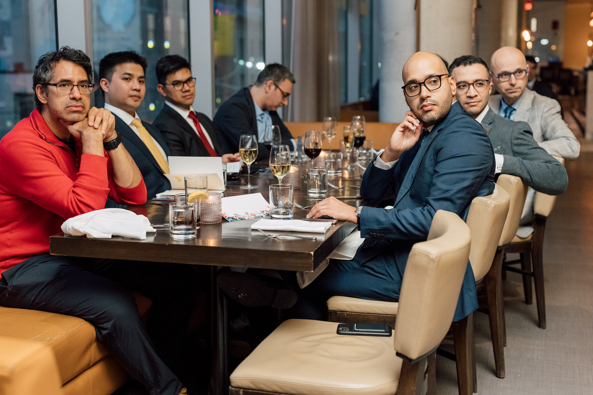A group of men celebrating graduation at a restaurant.
