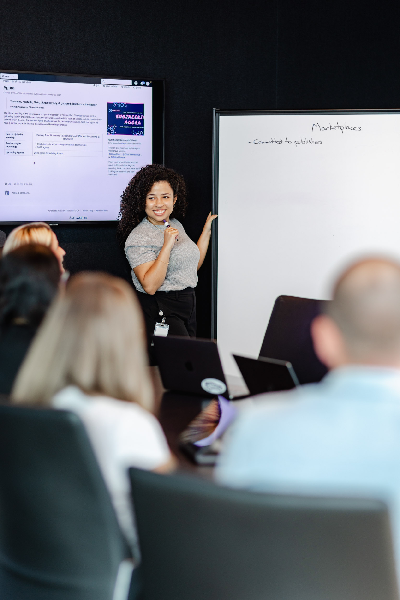 A woman presenting at a conference room during an Index Exchange event.