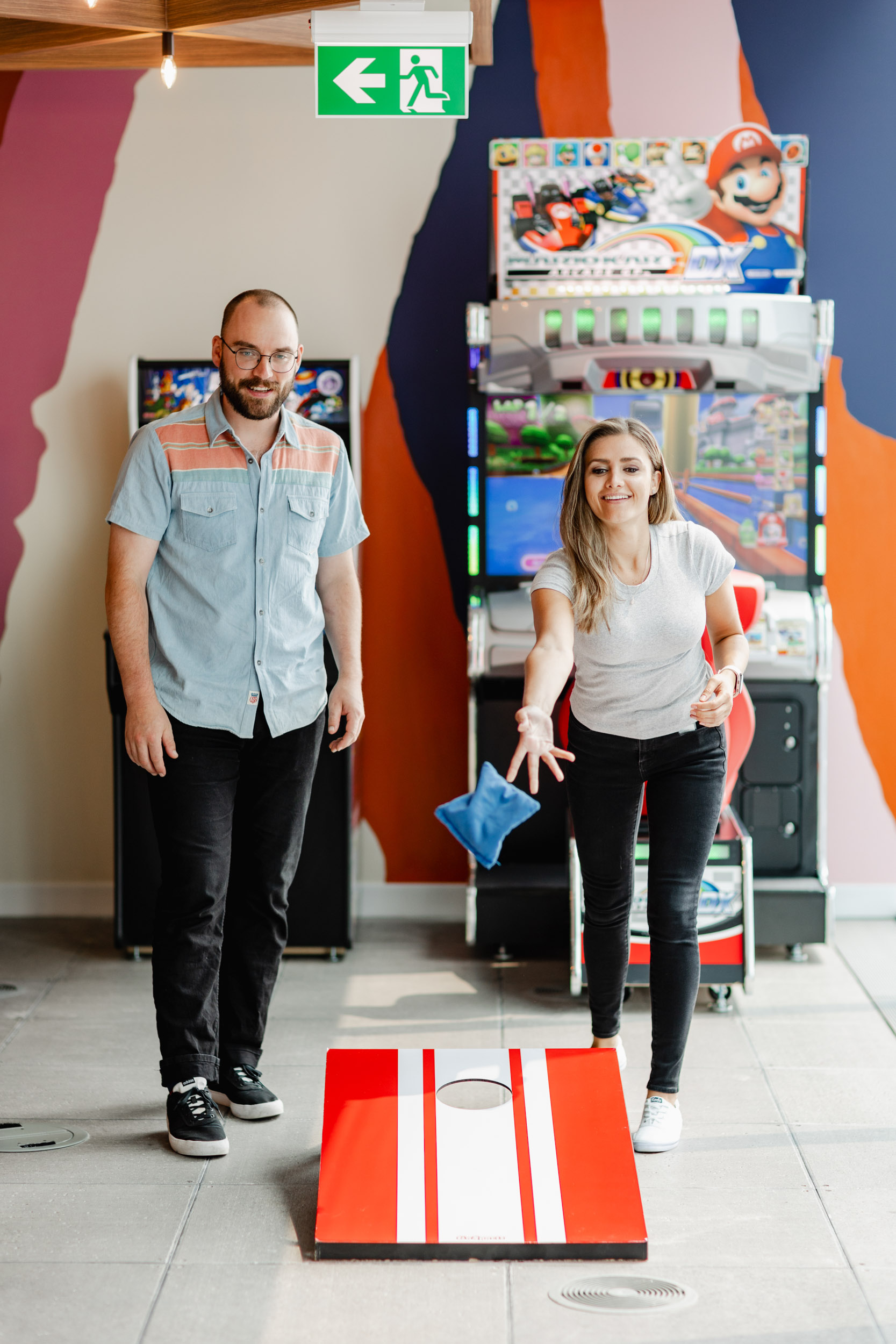 A couple playing a game of cornhole as part of an Index Exchange event.
