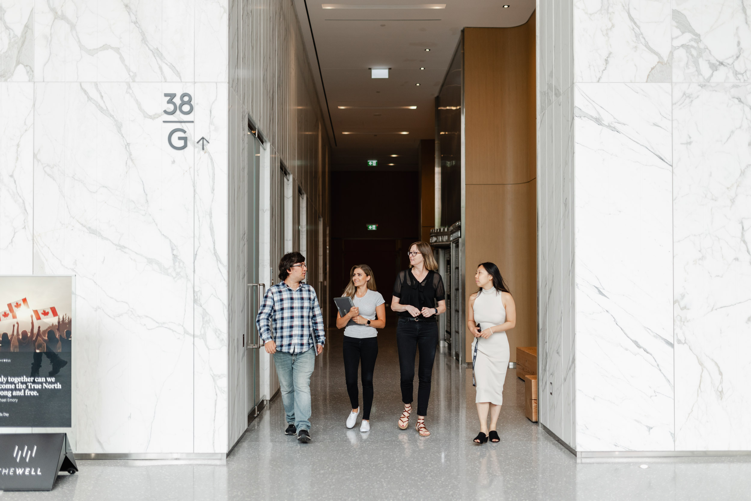 A group of people standing in the lobby of an Index Exchange office building.