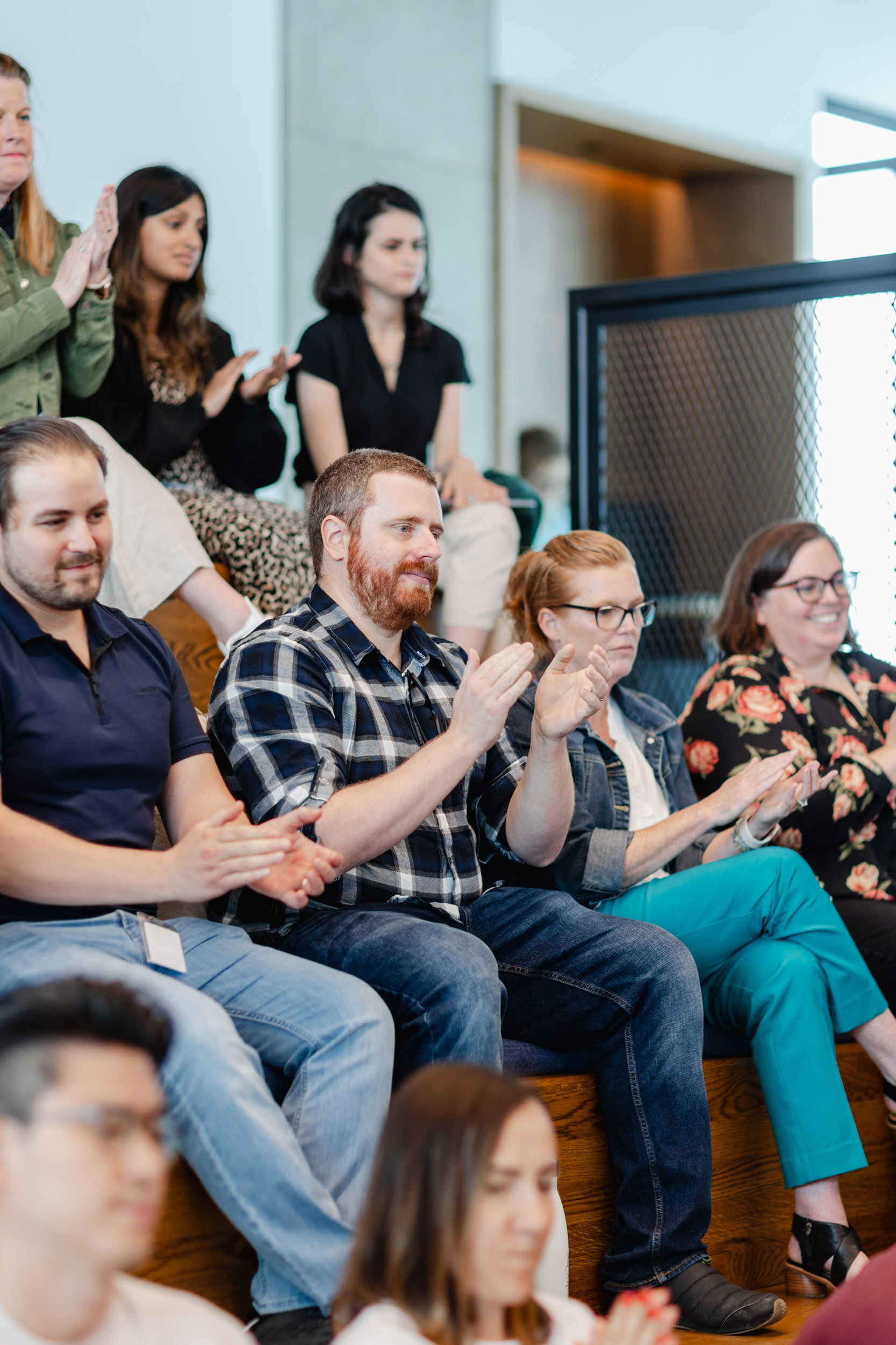 A group of people clapping at an Index Exchange event.