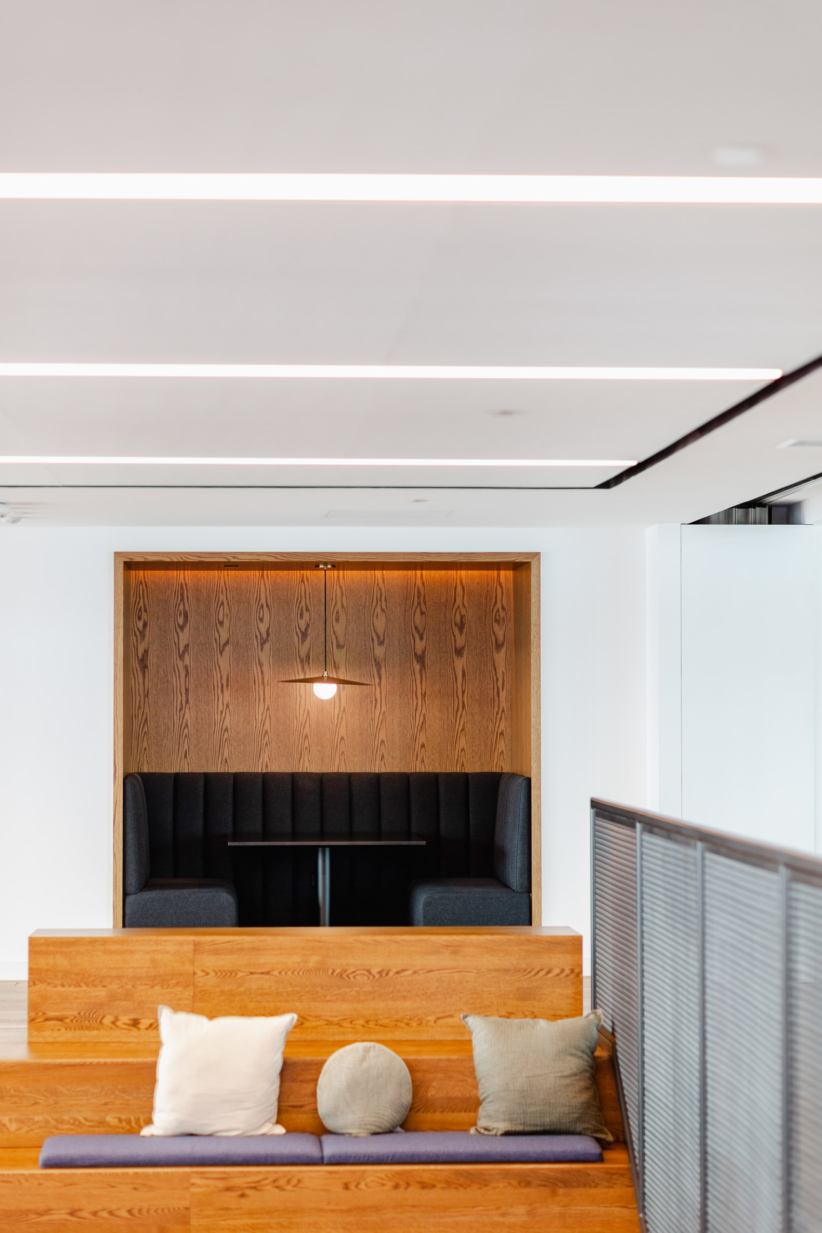 An office with a wooden bench and a wooden wall featuring Index Exchange.