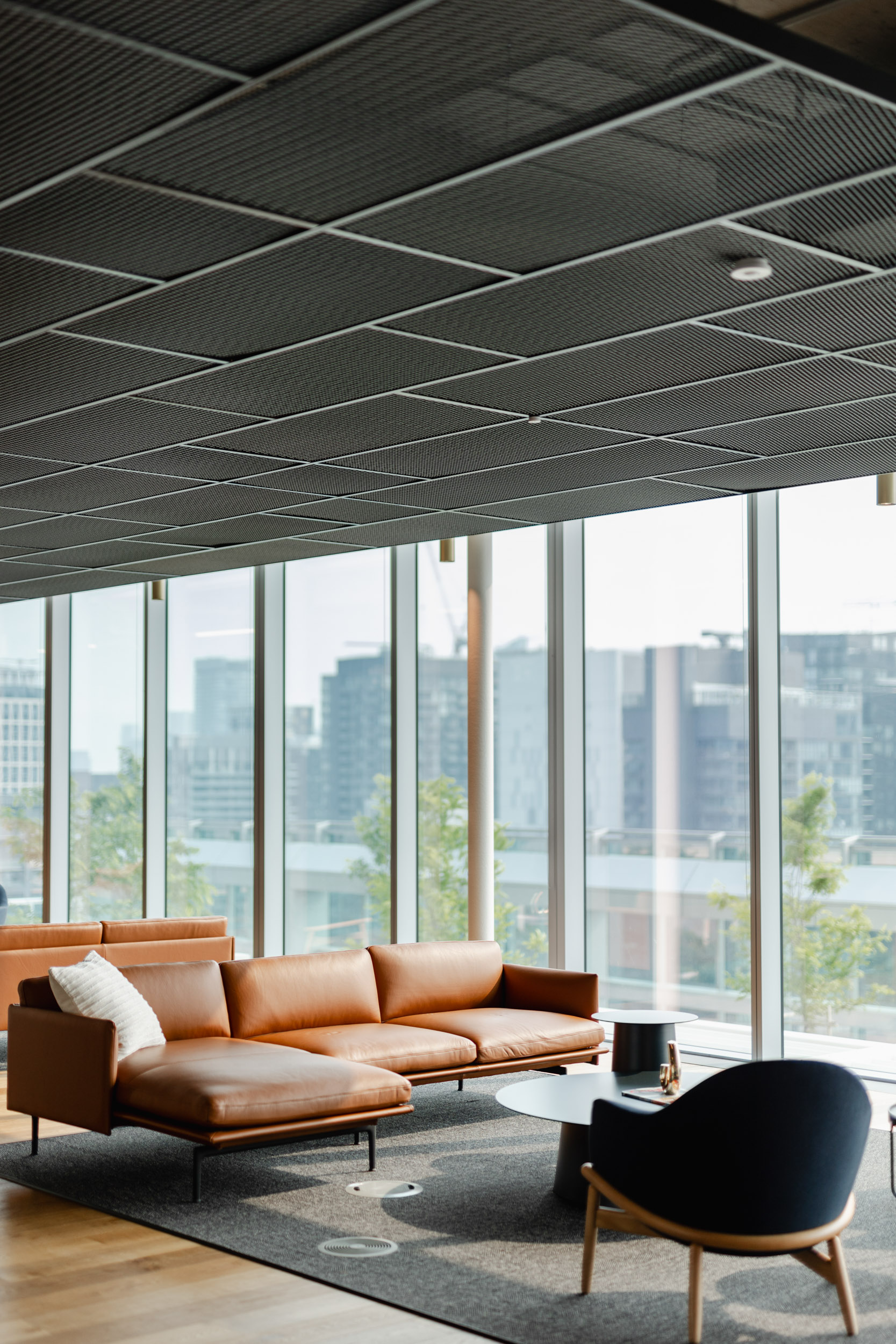 A living room with couches and a view of the city overlooking Index Exchange.