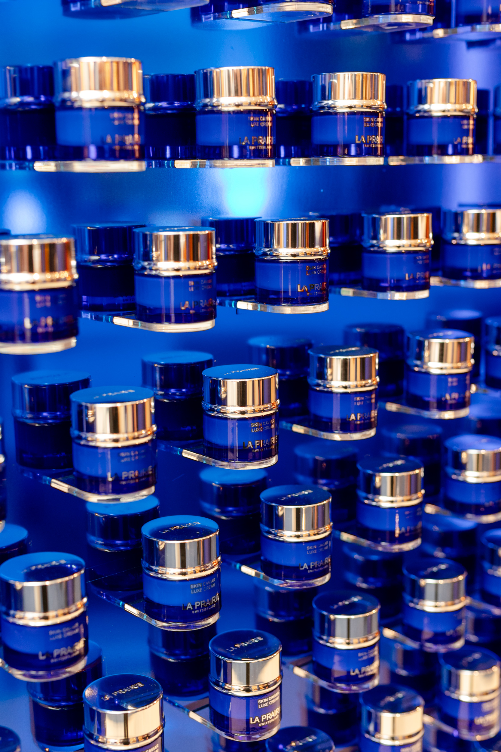 A line of azure jars on a rack.