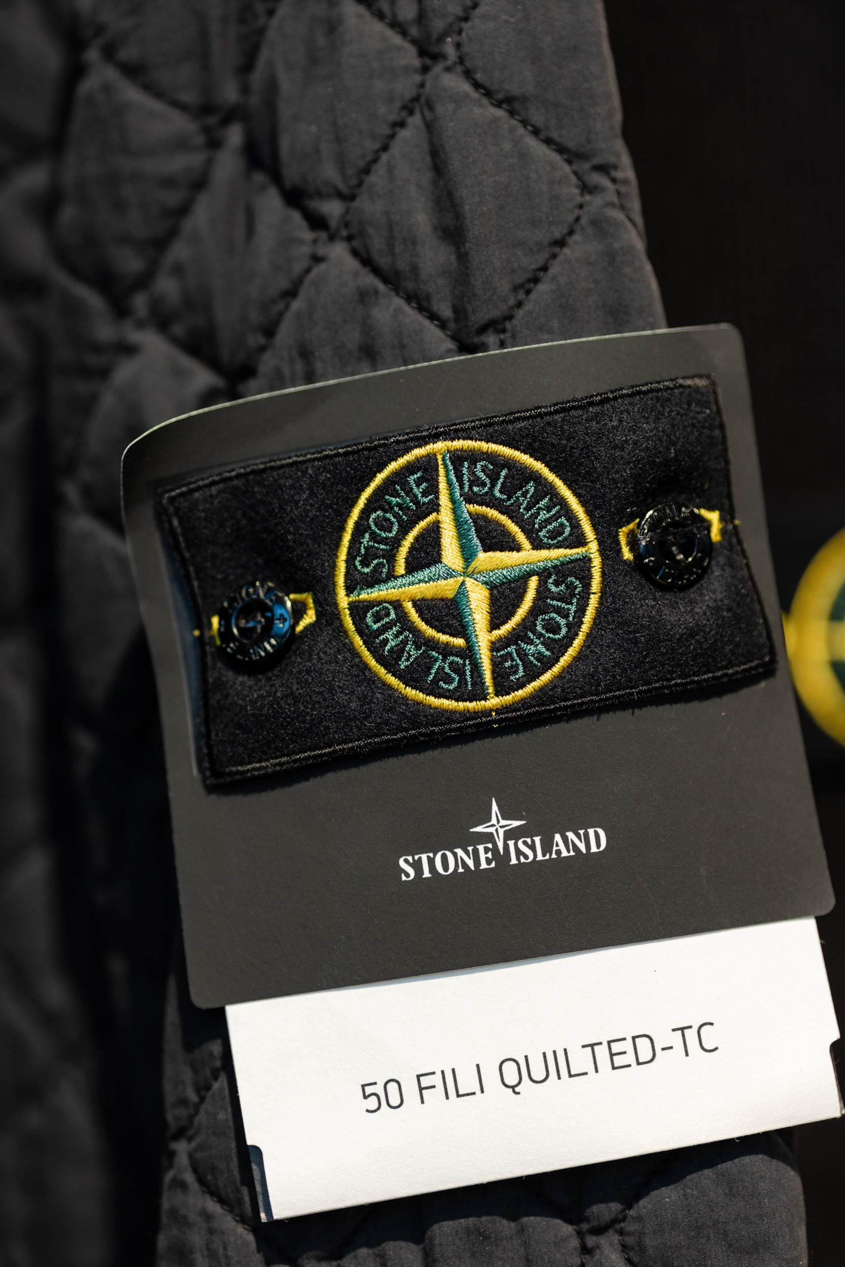 Jacket with a Stone Island logo.