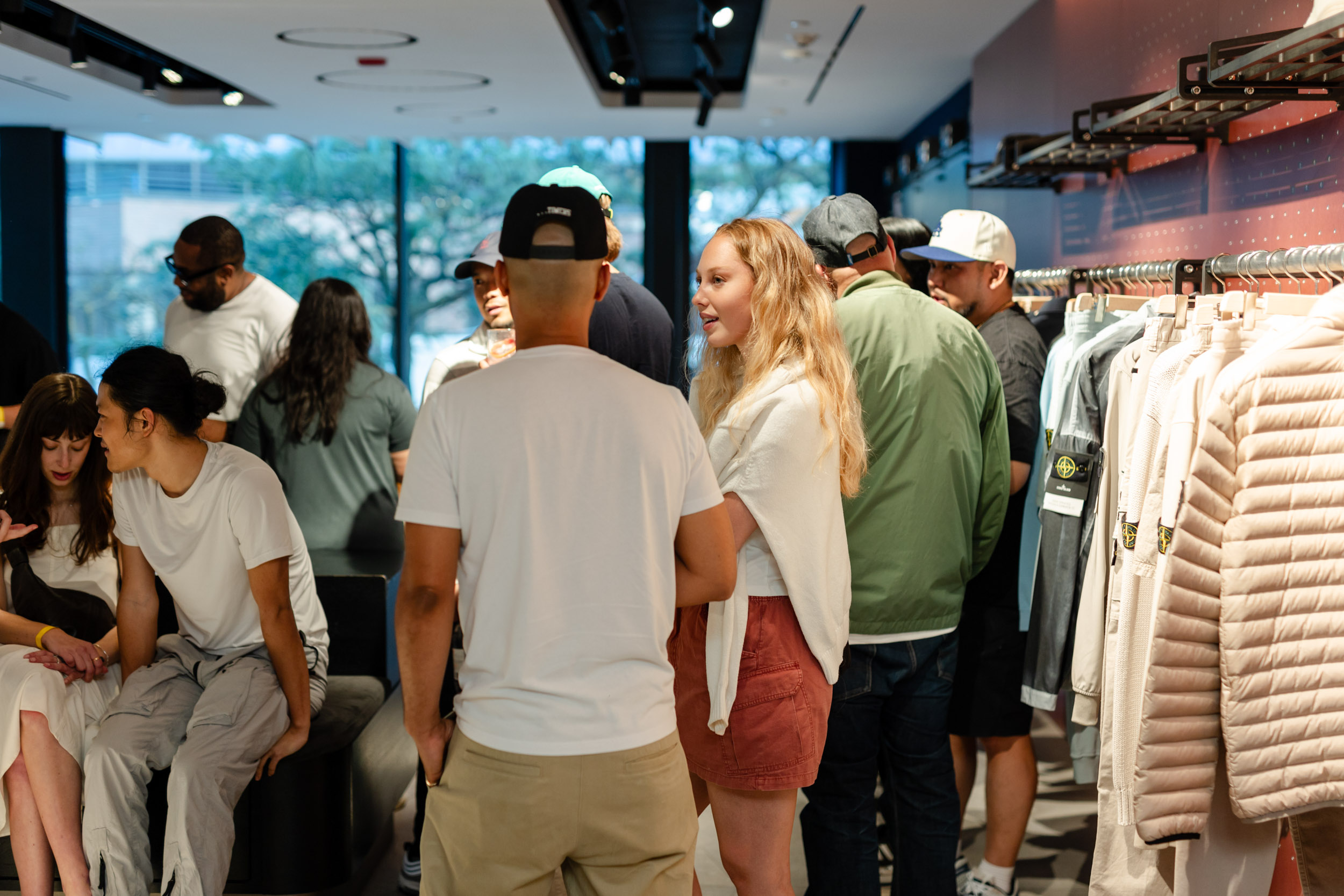 A group of people exploring Stone Island Store in Yorkville