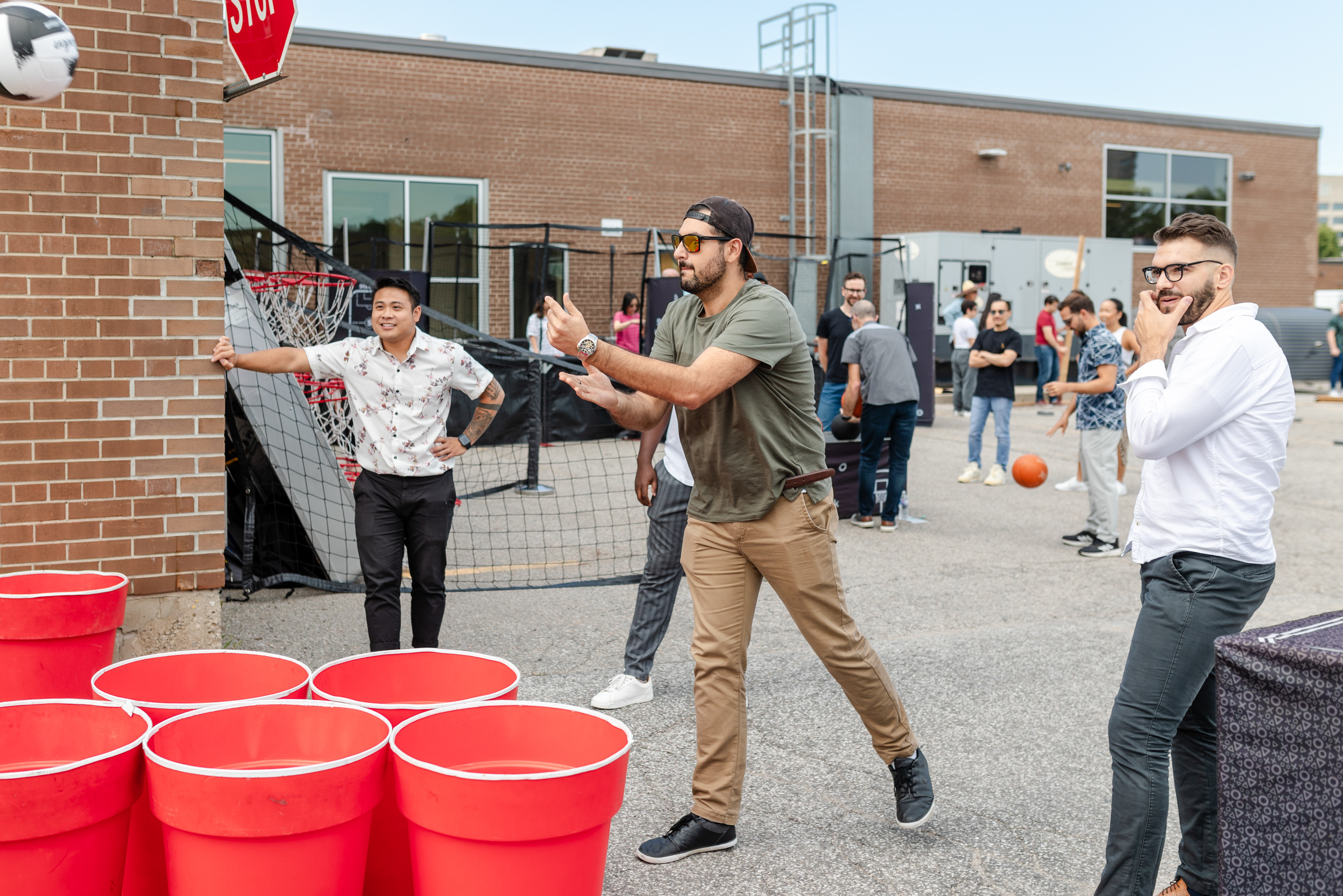 A group of people playing a game of beer pong.