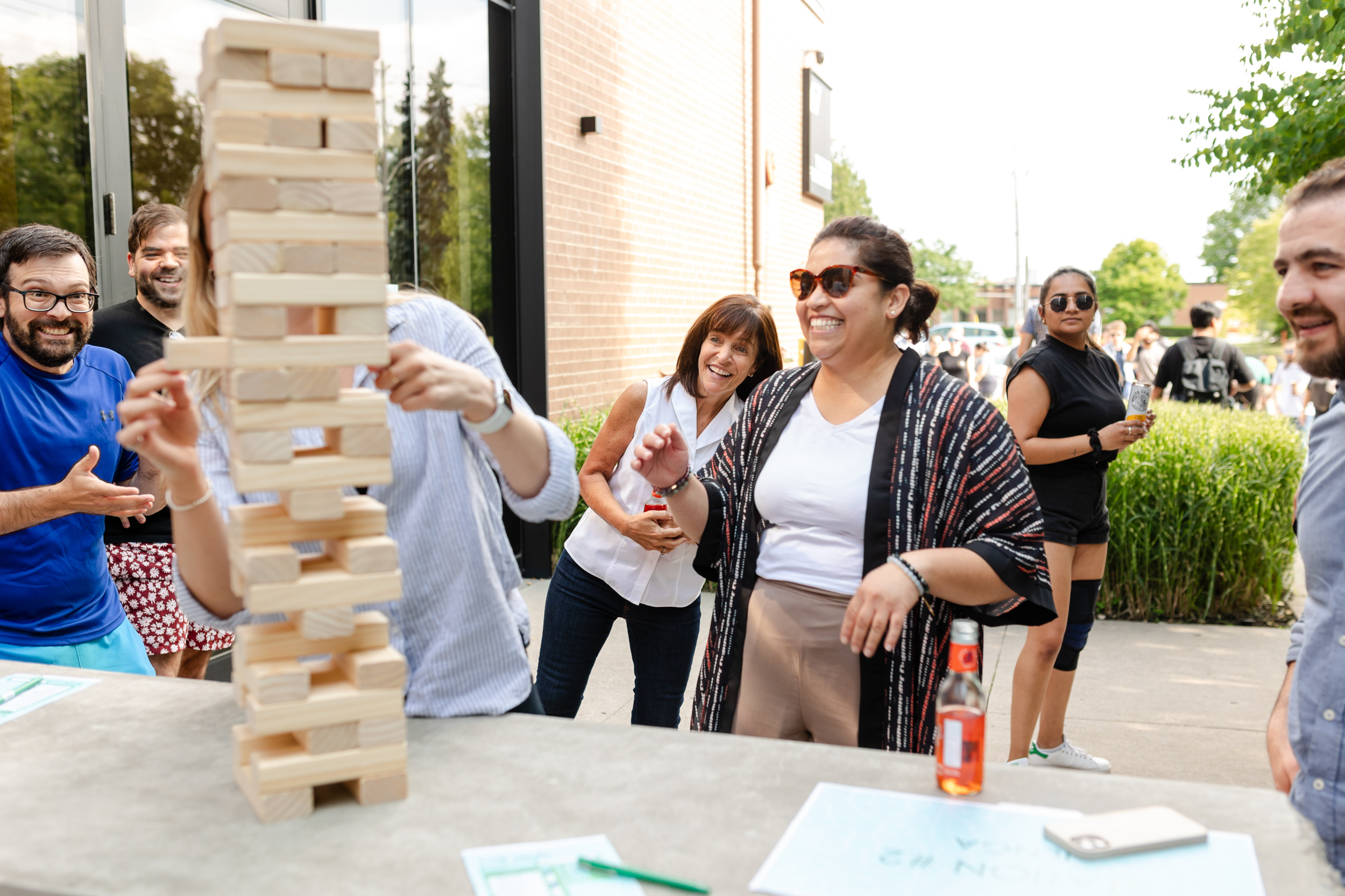 Social event of people playing a game of jenga captured through photography.