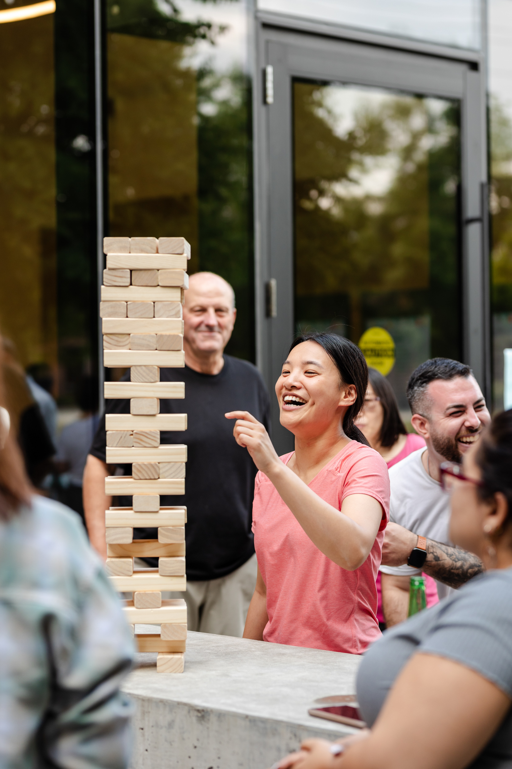 Social Event Photography capturing a group of people playing a game of Jenga.