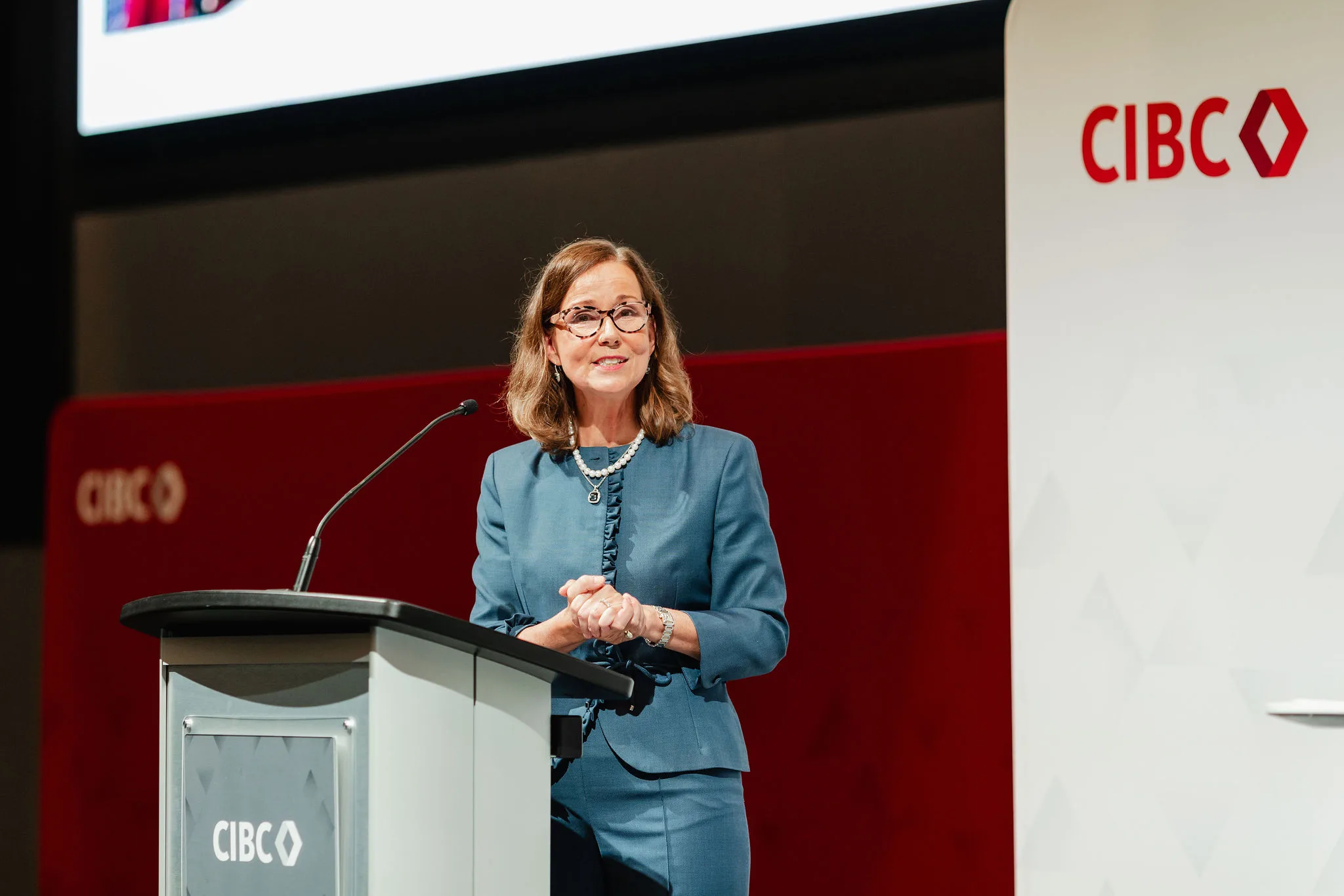 A woman podium CIBC sign.