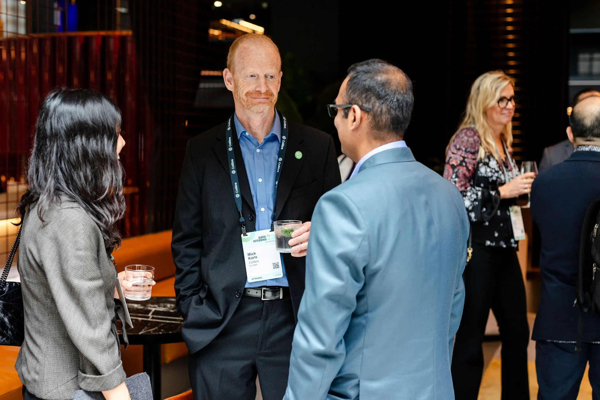 A gathering of individuals engaging in conversation at an event.