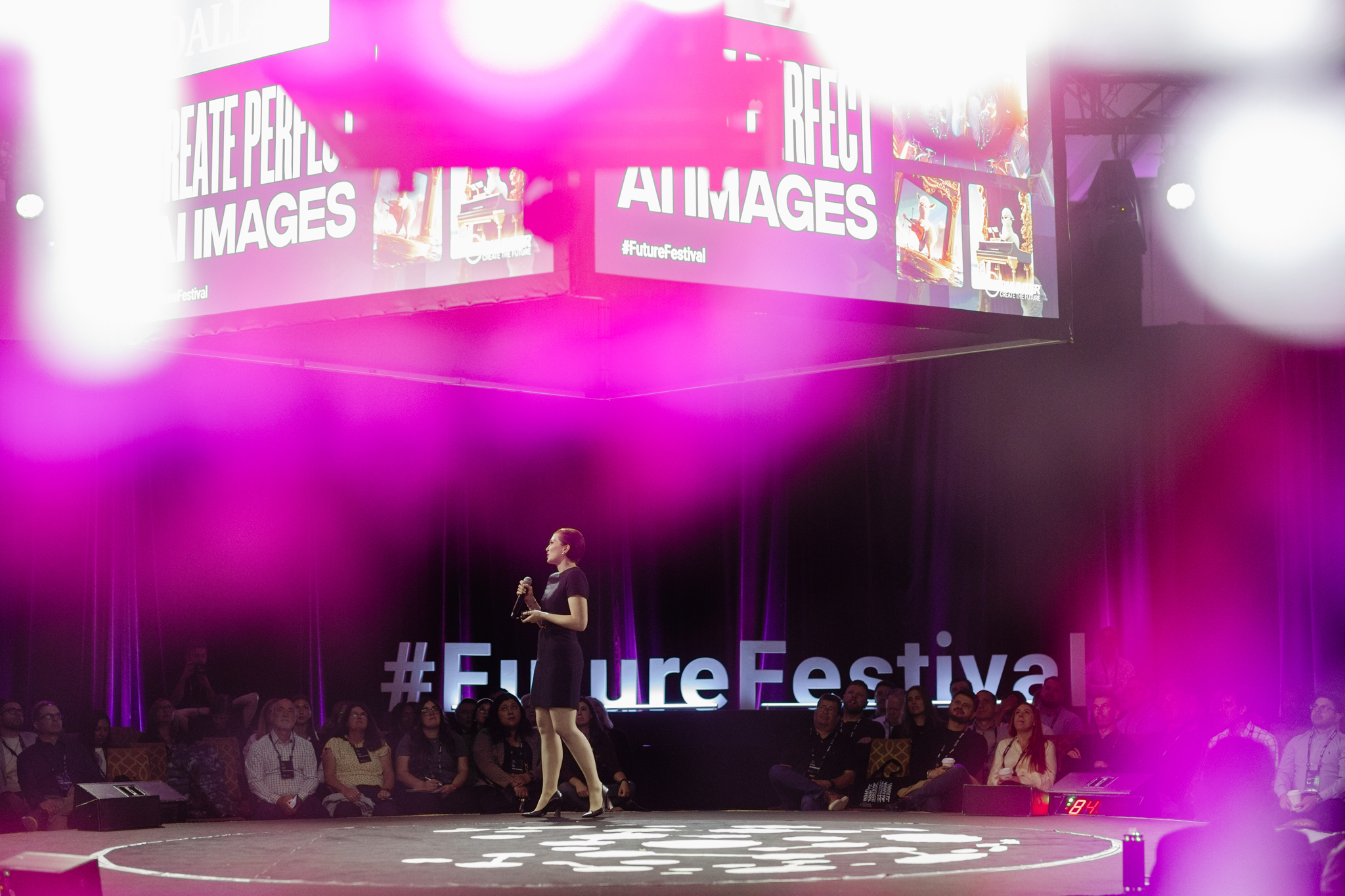A woman captivating the audience on stage at the future festival.