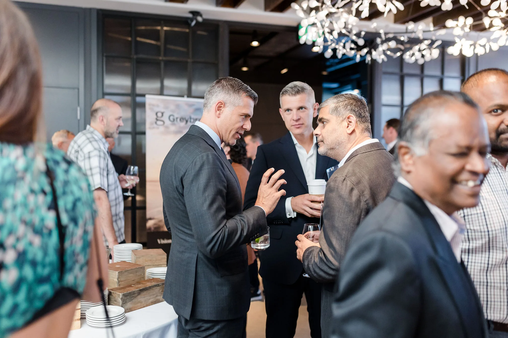 A group of individuals conversing at an event.