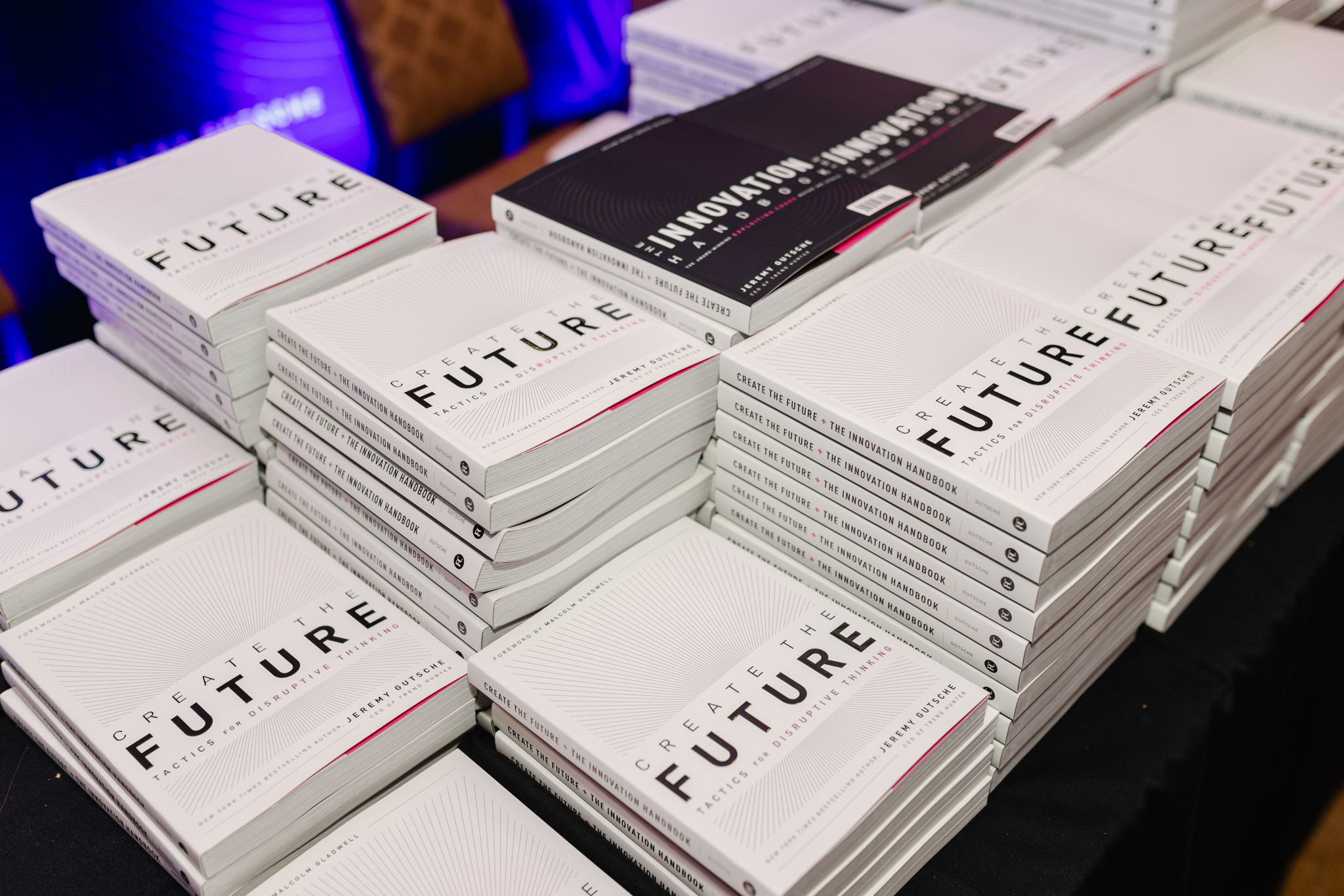 A stack of books on a table captured at an event.