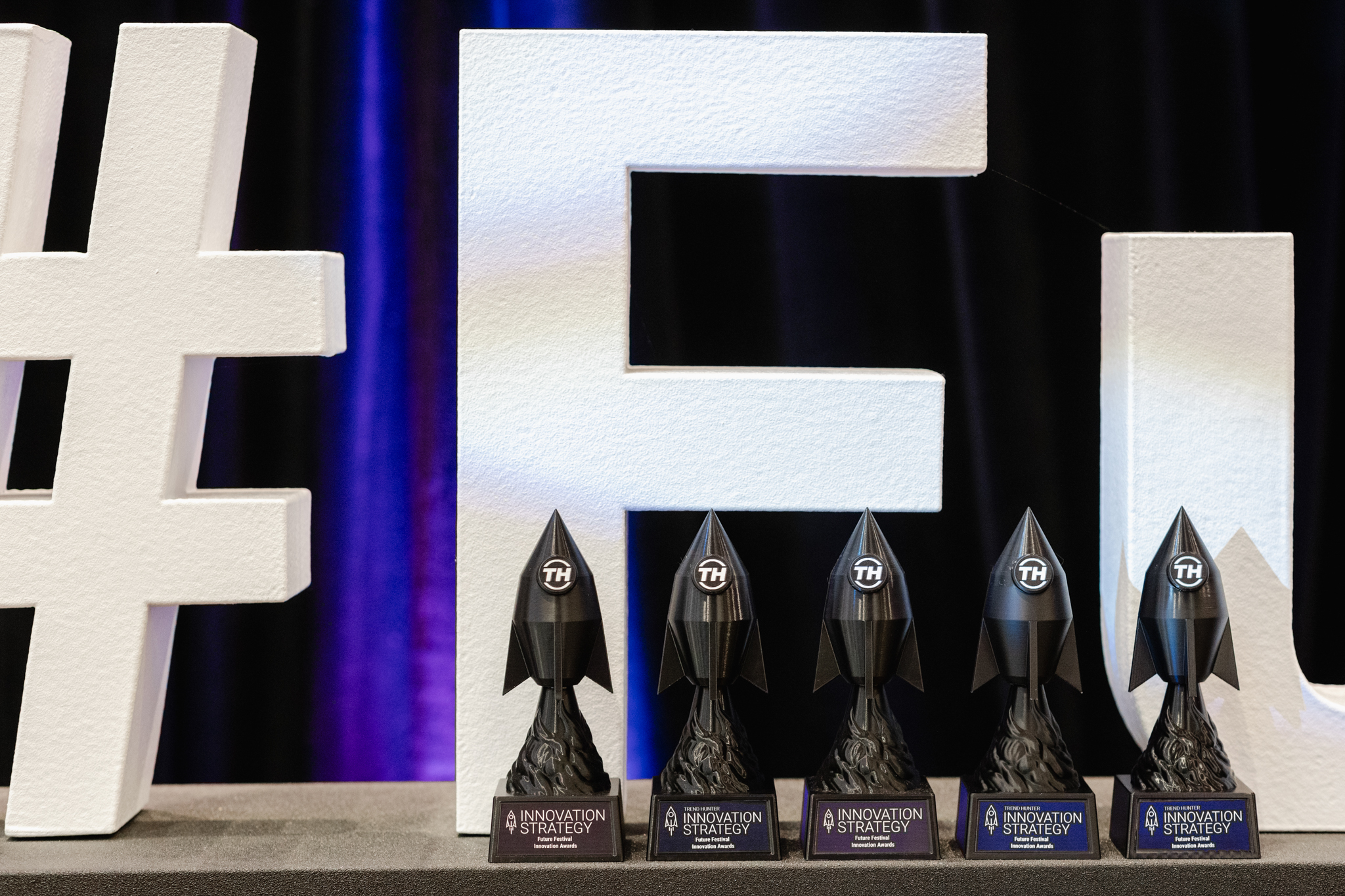 A collection of trophies displayed prominently alongside the word fu, captured beautifully through event photography.
