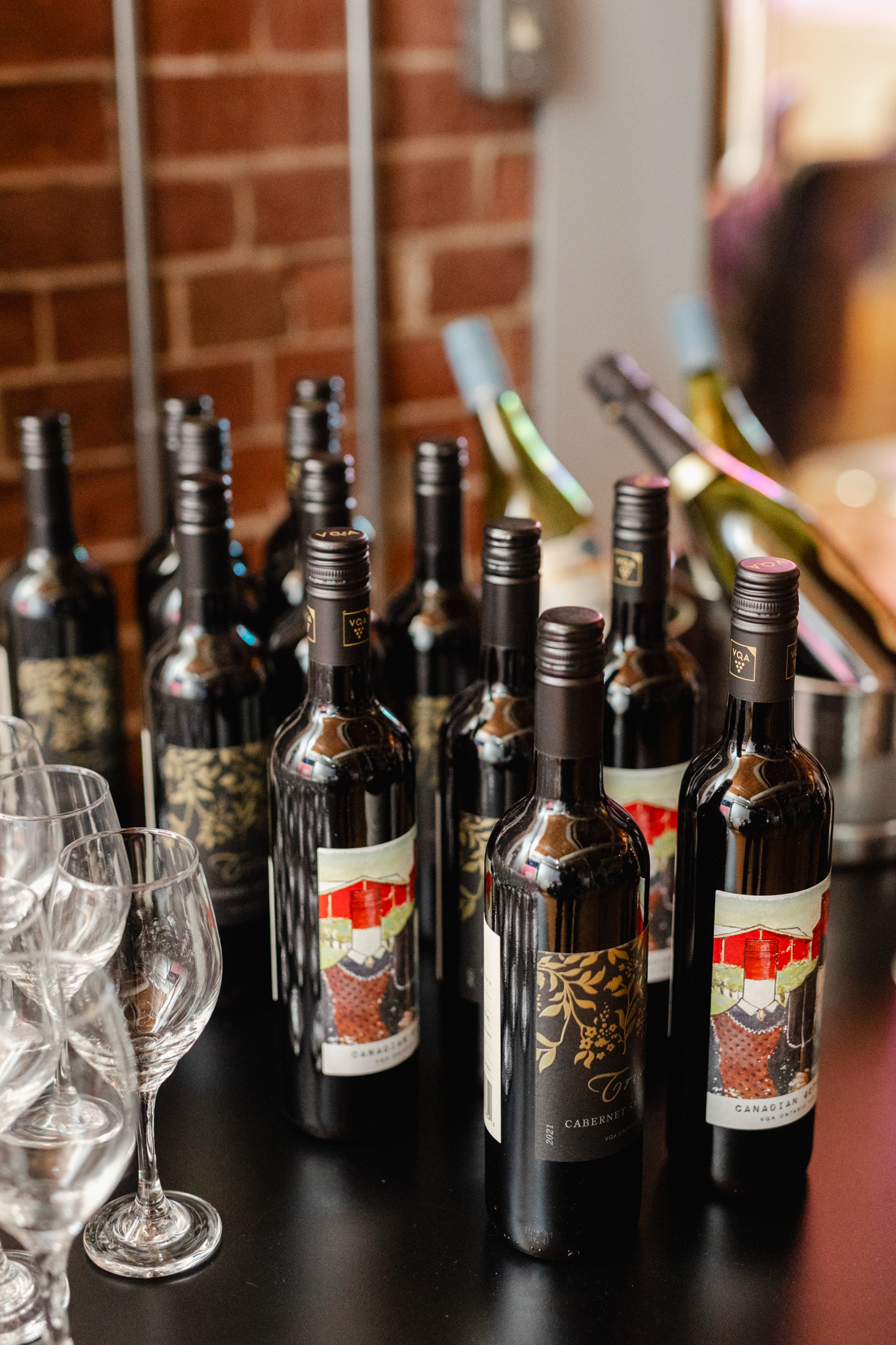 The bottles of wine are elegantly arranged on a table at the event, ready to be captured by an event photographer.