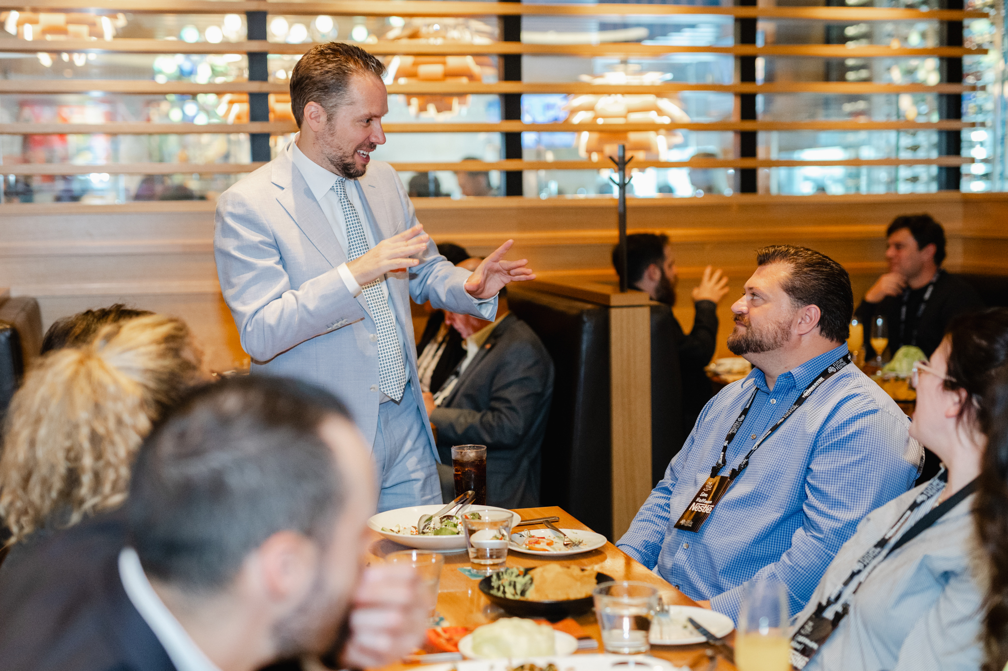 An individual giving a speech to a gathering at a restaurant.