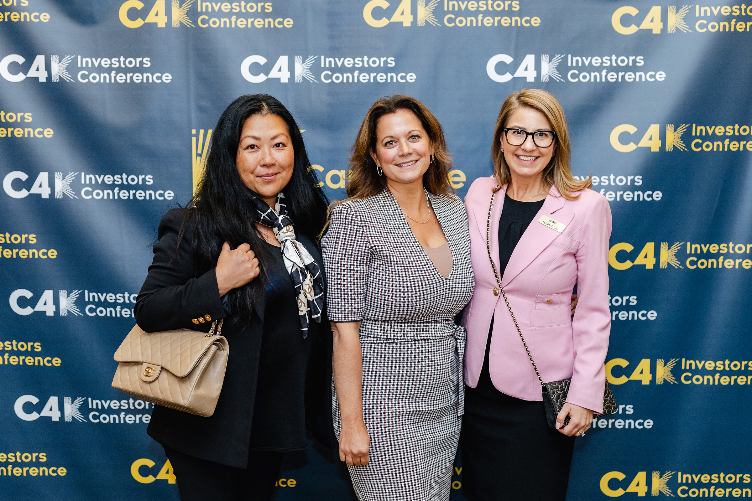 Three women posing for a photo at the event conference.