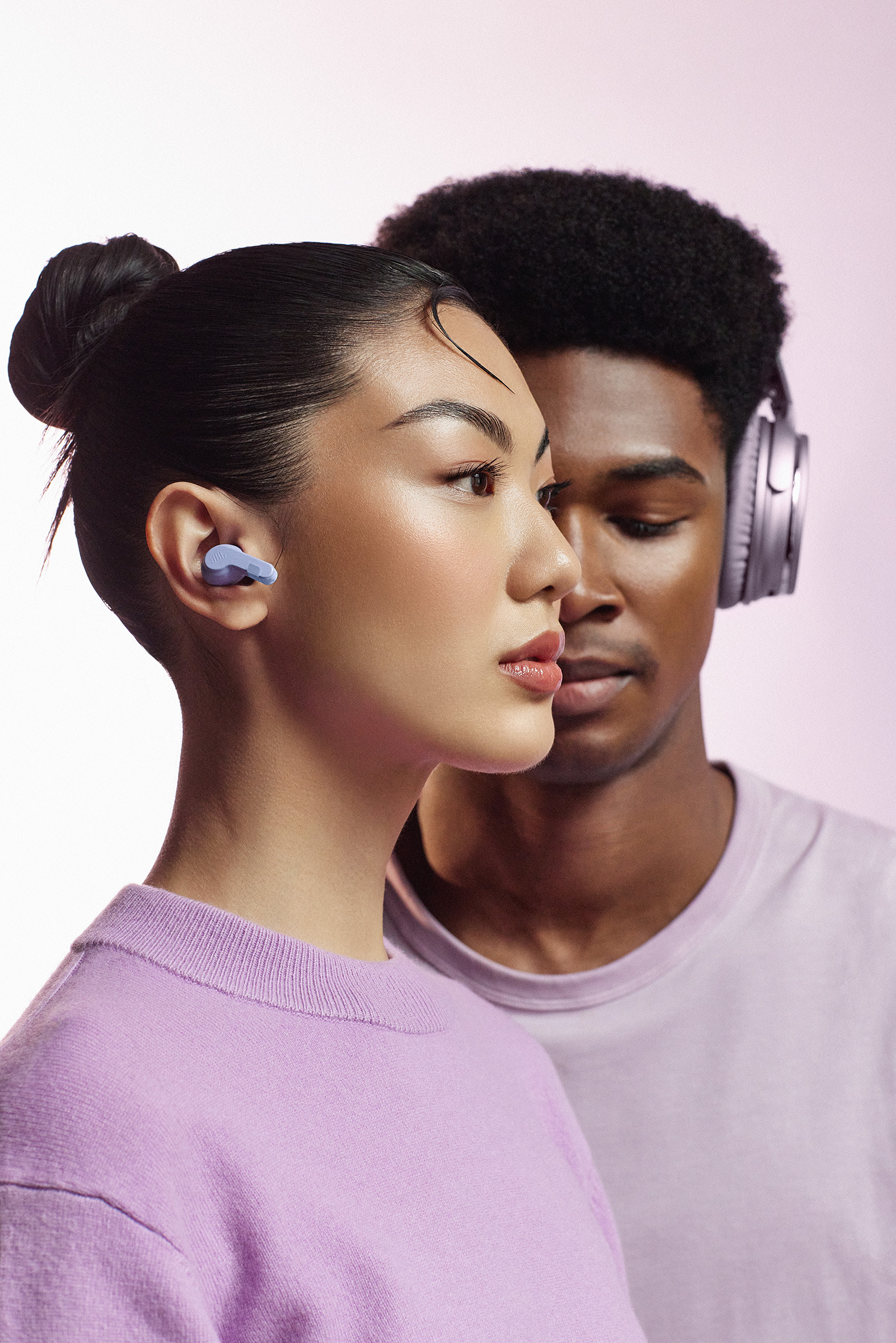 A man and a woman wearing headphones.