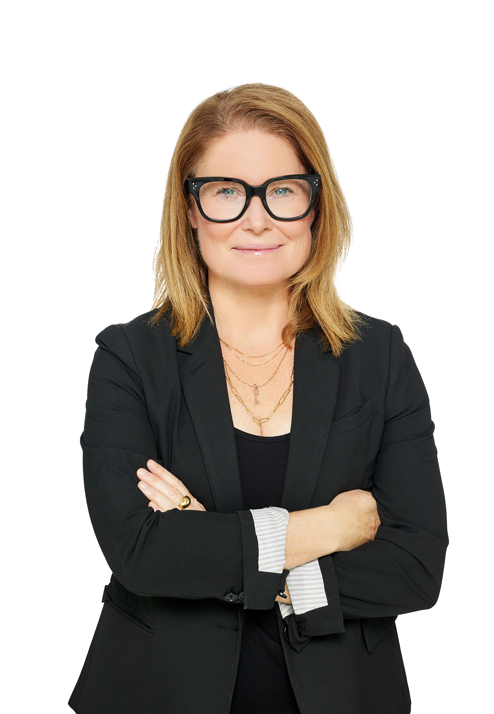 A woman in glasses posing for an event photography photo.