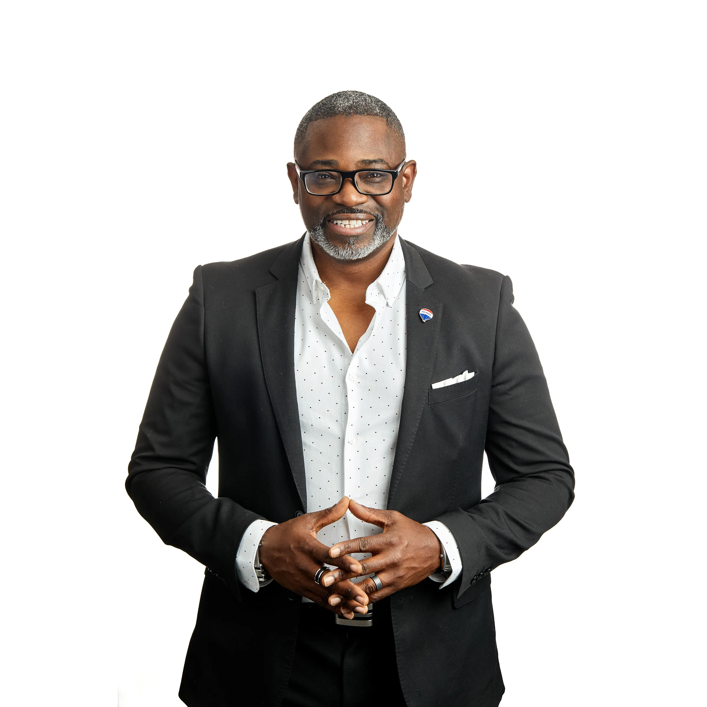A black man in a suit posing for a photo.