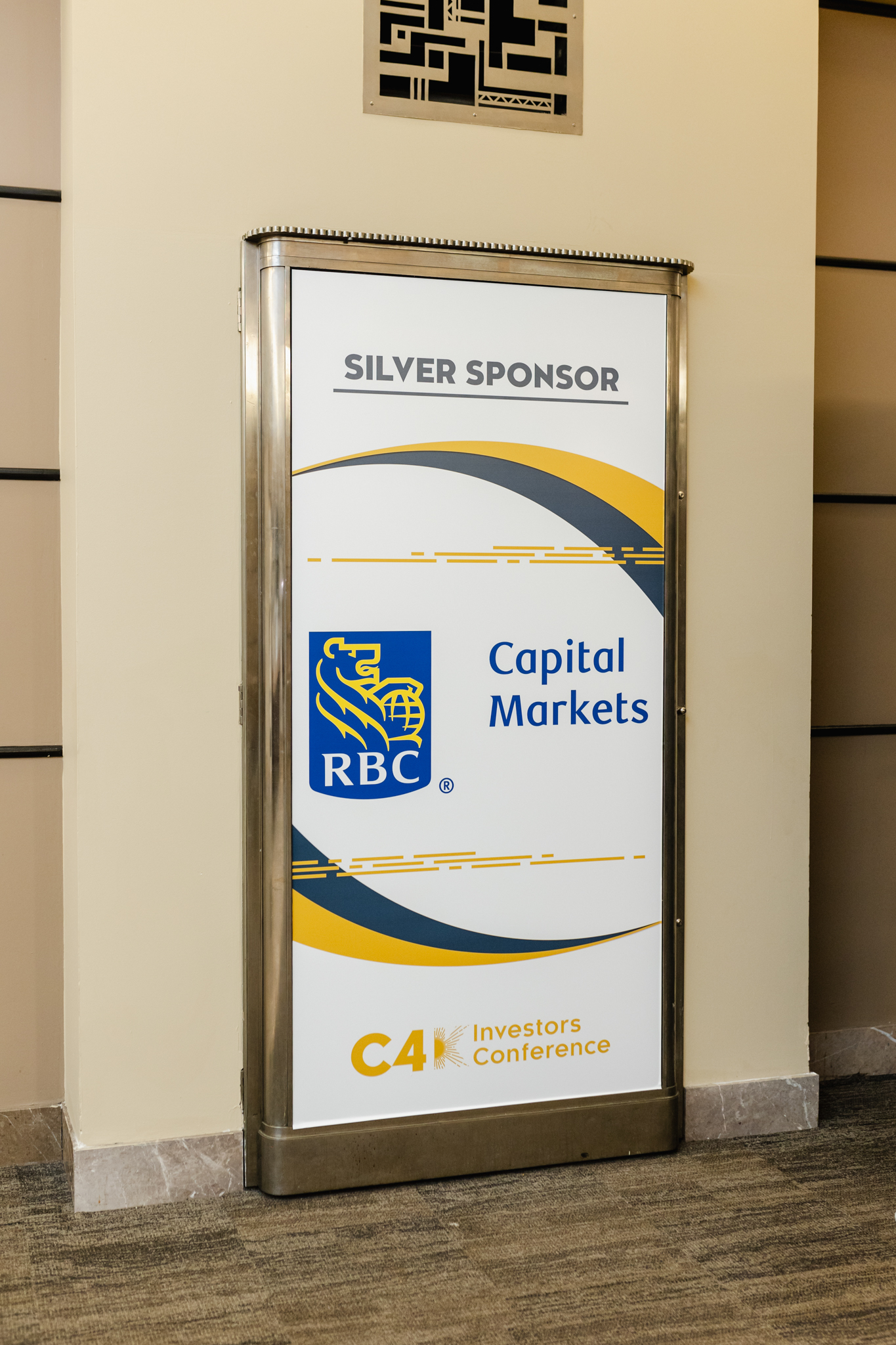 A Conference Photography sign advertising capital markets in a lobby.