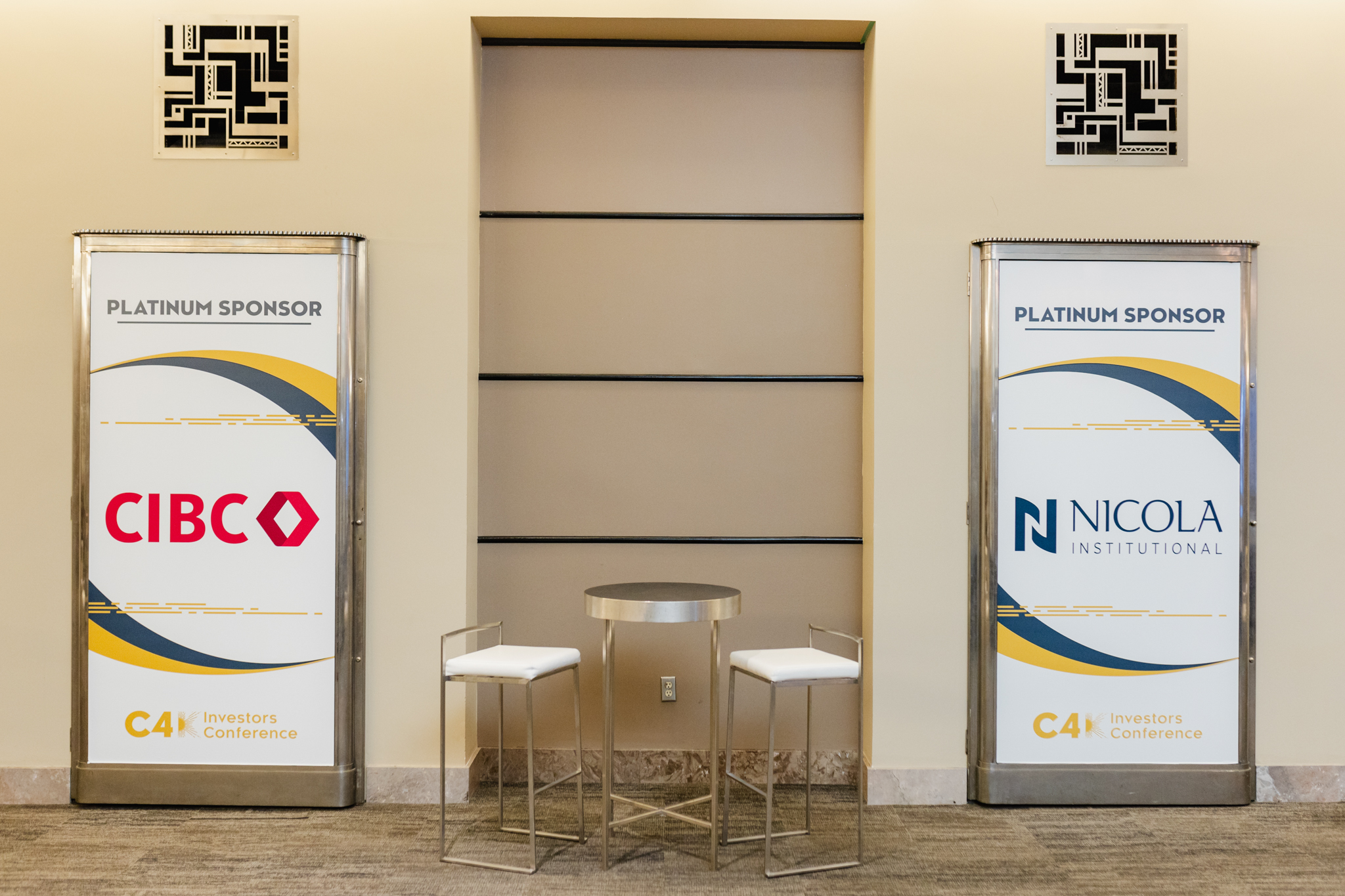 Two large conference banners in the lobby of a building.