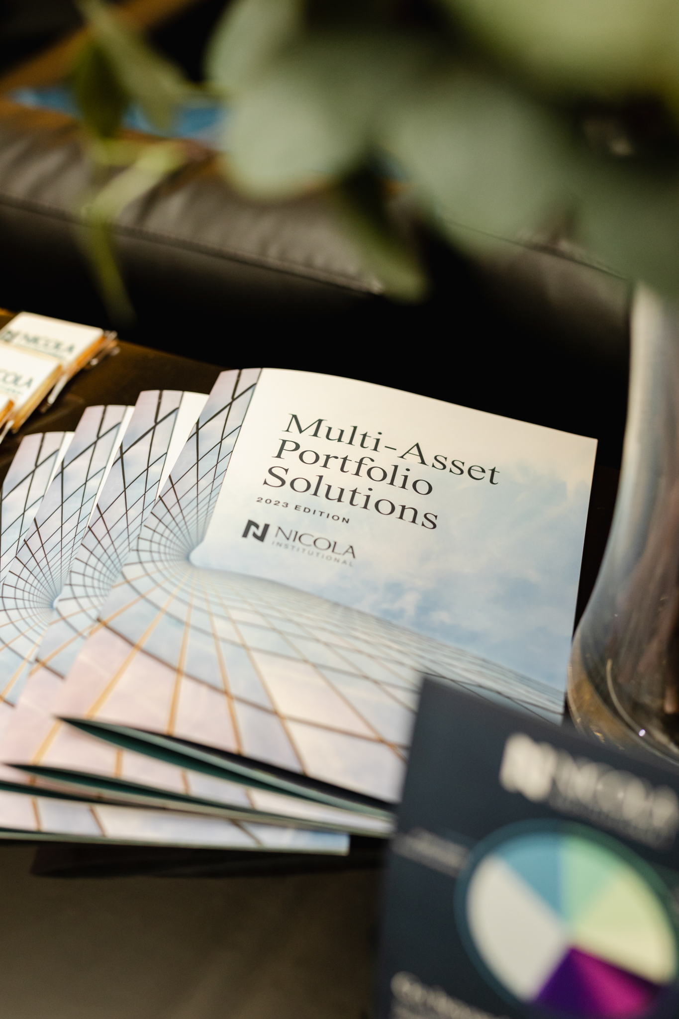 Multi-asset portfolio solutions brochures on a conference table.